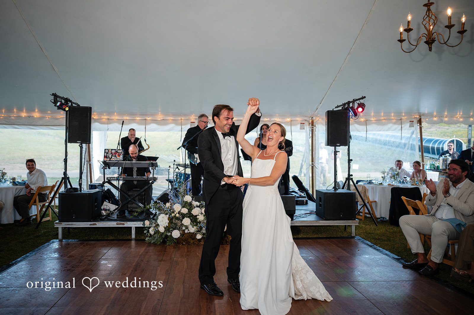 Emilia + Charlie A bride and groom dancing together in front of a live band.