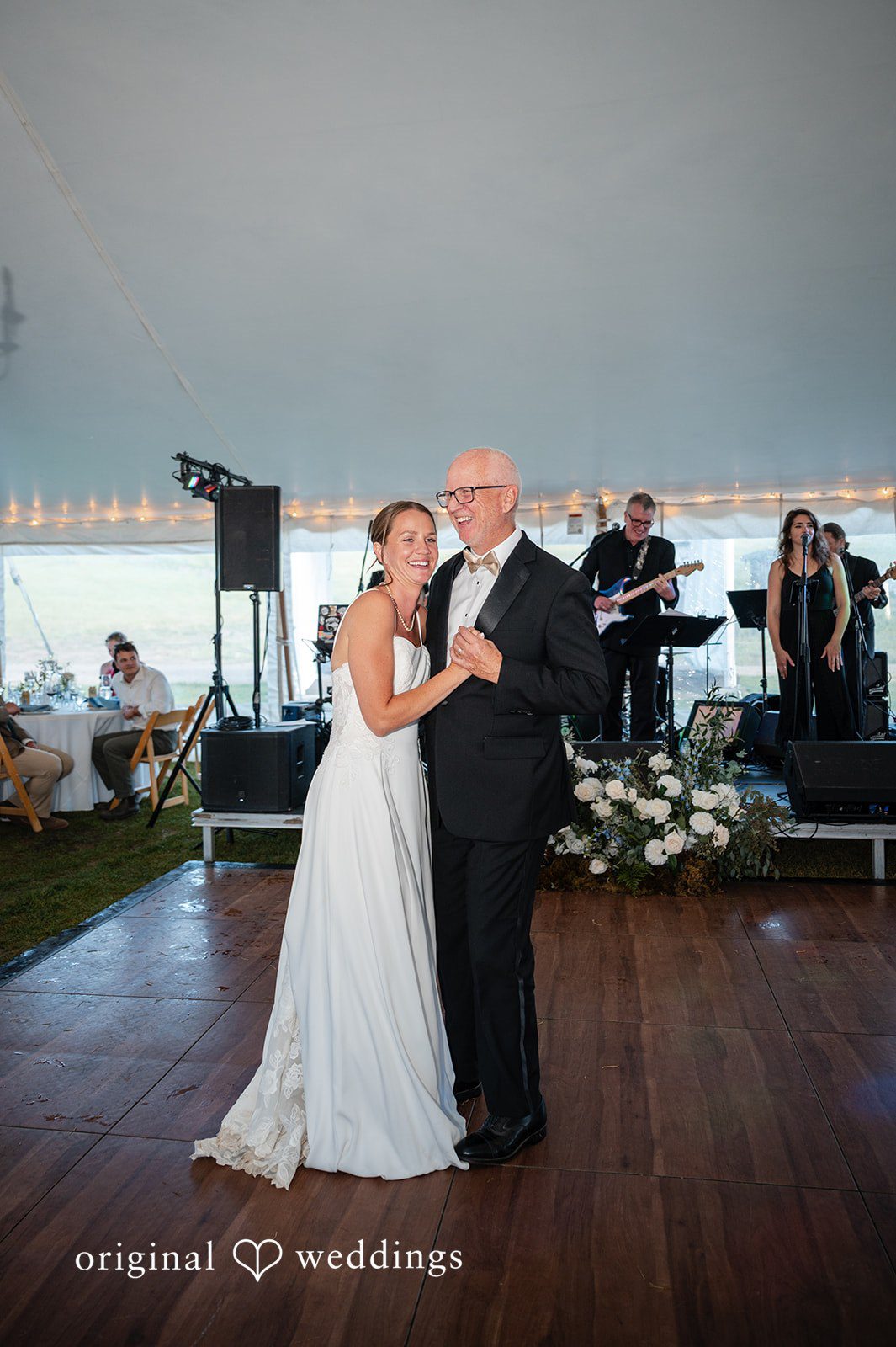 Emilia + Charlie A bride dancing with a man in a suit on a dance floor.