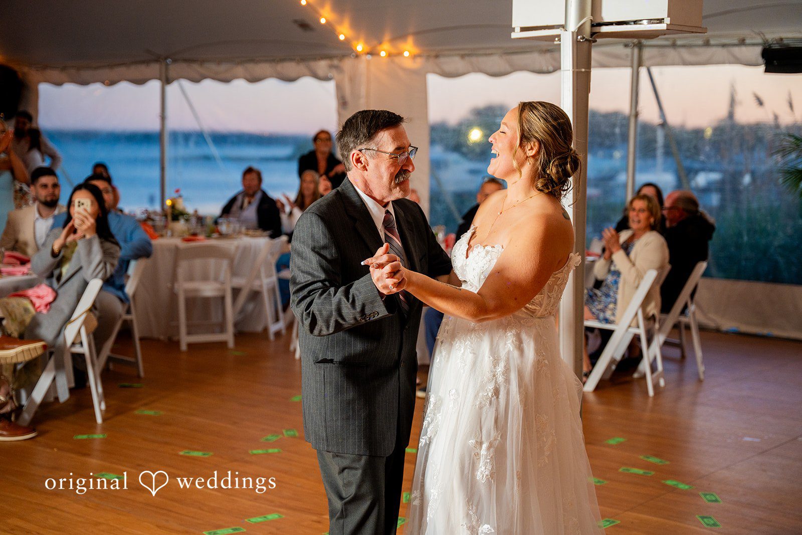 Alex + Courtney A bride and man dancing together surrounded by seated guests.