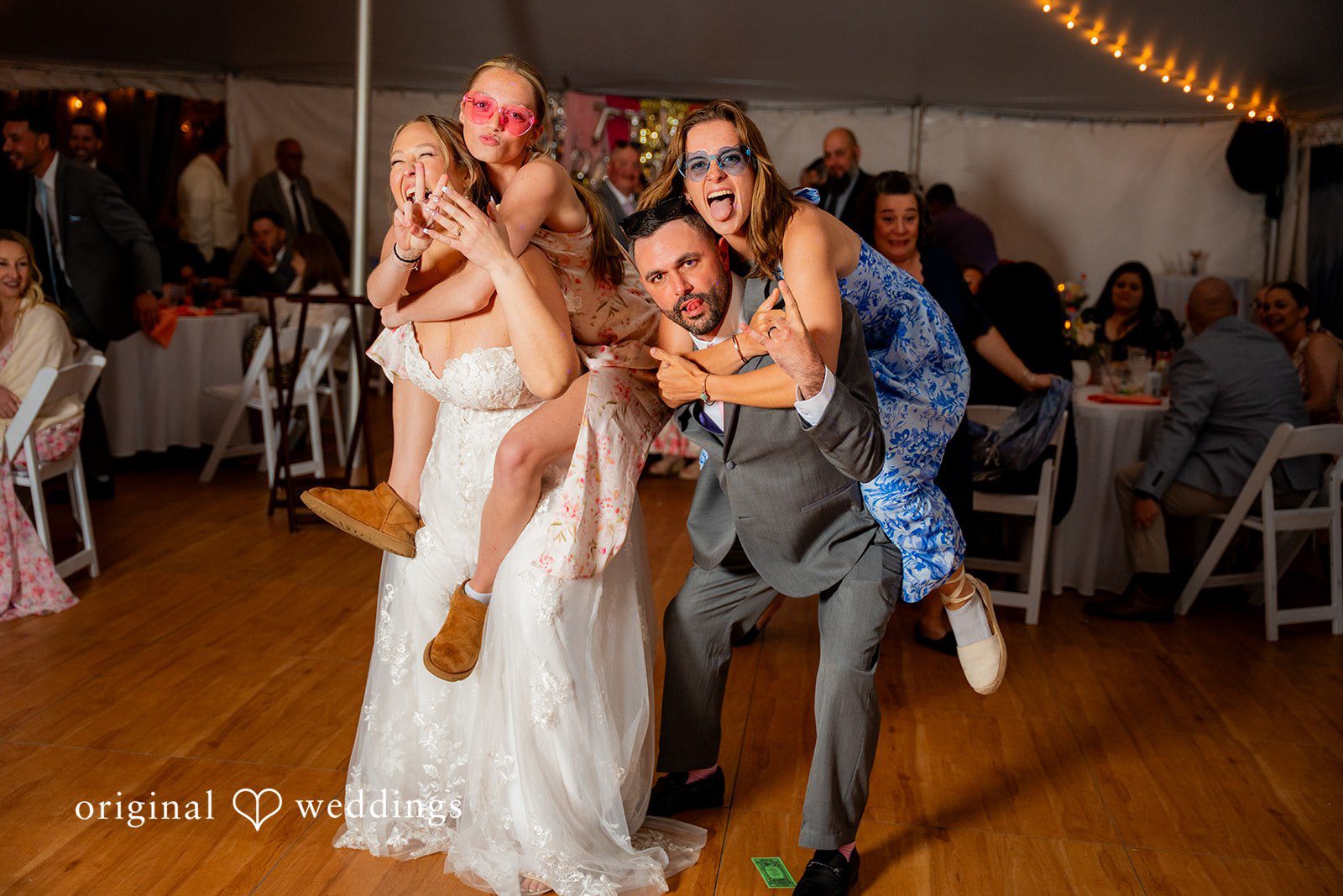 Alex + Courtney Wedding guests dancing and celebrating enthusiastically at a reception.
