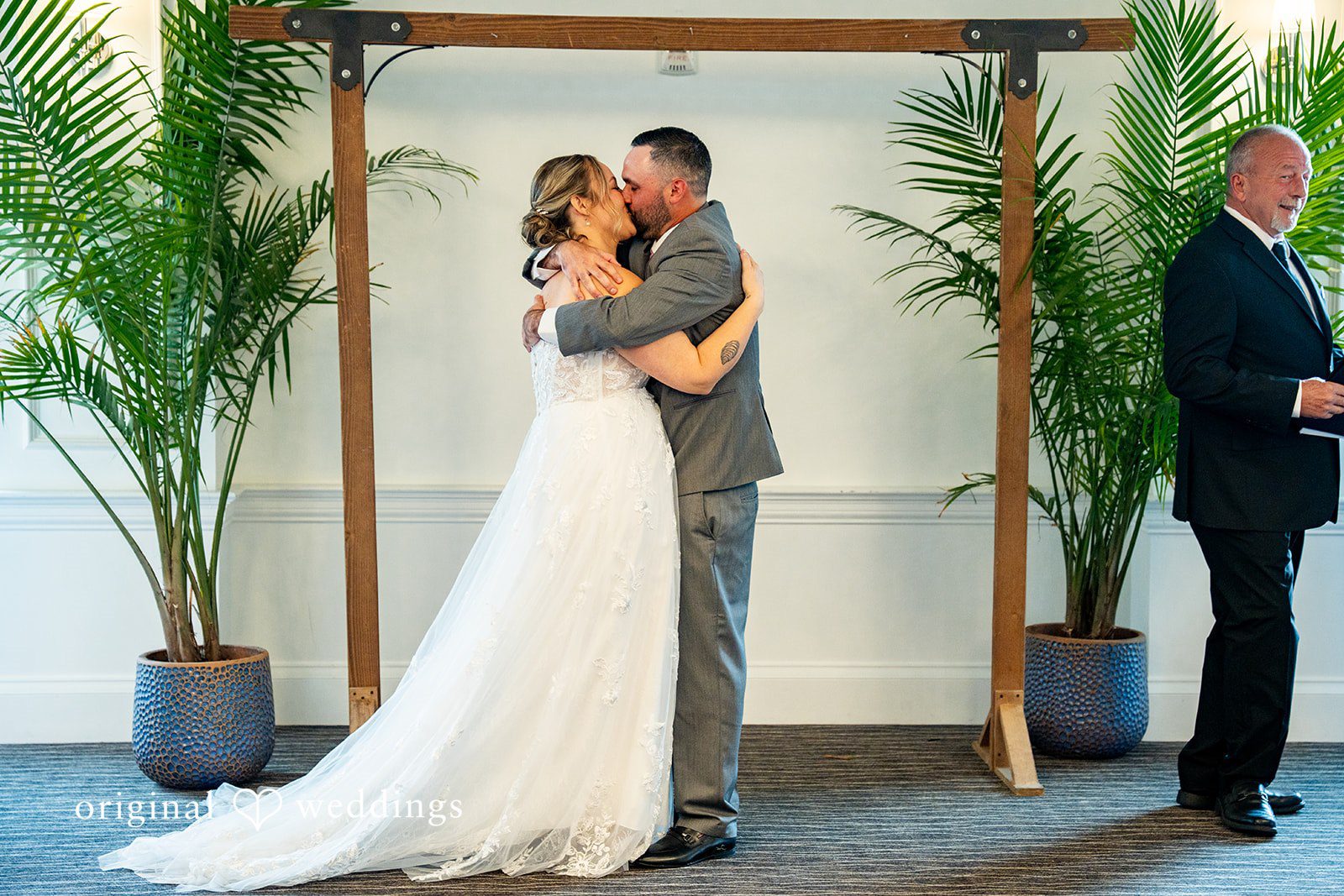 Alex + Courtney A bride and groom sharing a kiss during their ceremony.