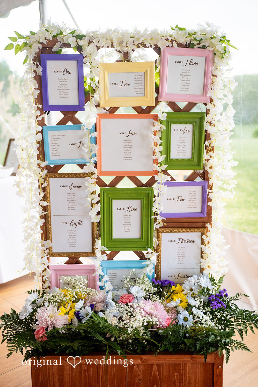 Alex + Courtney A floral seating chart display framed in green wood.