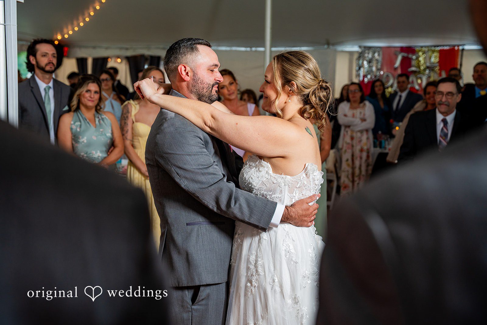 Alex + Courtney A bride and groom dancing together at their wedding reception.