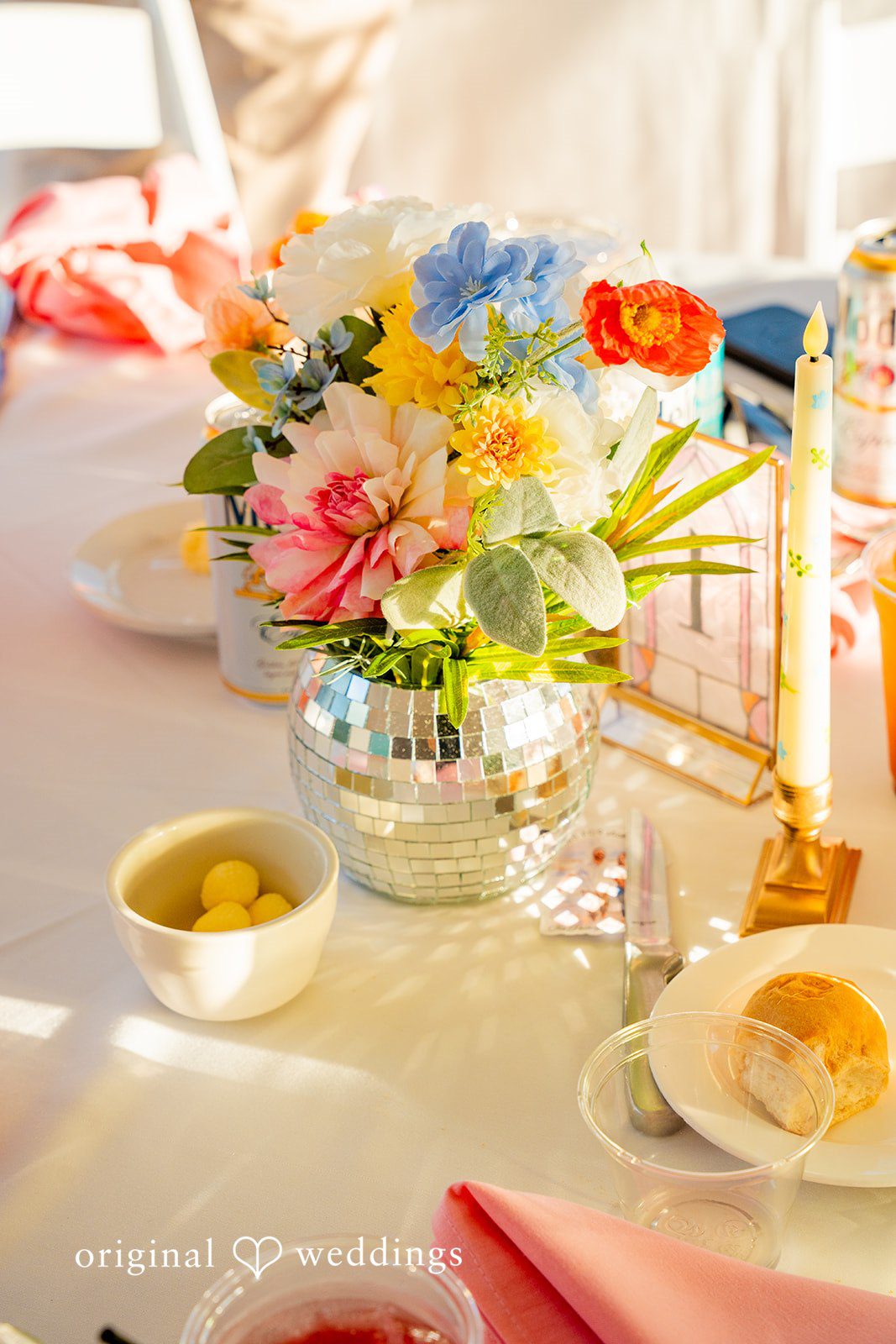 Alex + Courtney A reception table setup featuring a vibrant floral centerpiece.