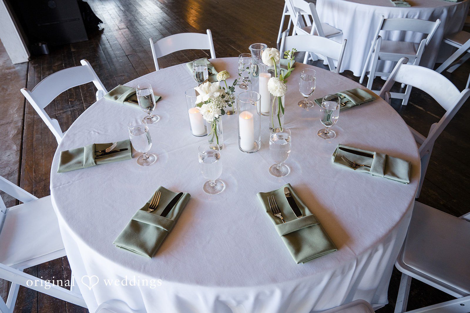 Hanna + Austin Overhead view of a set dinner table with cloth napkins