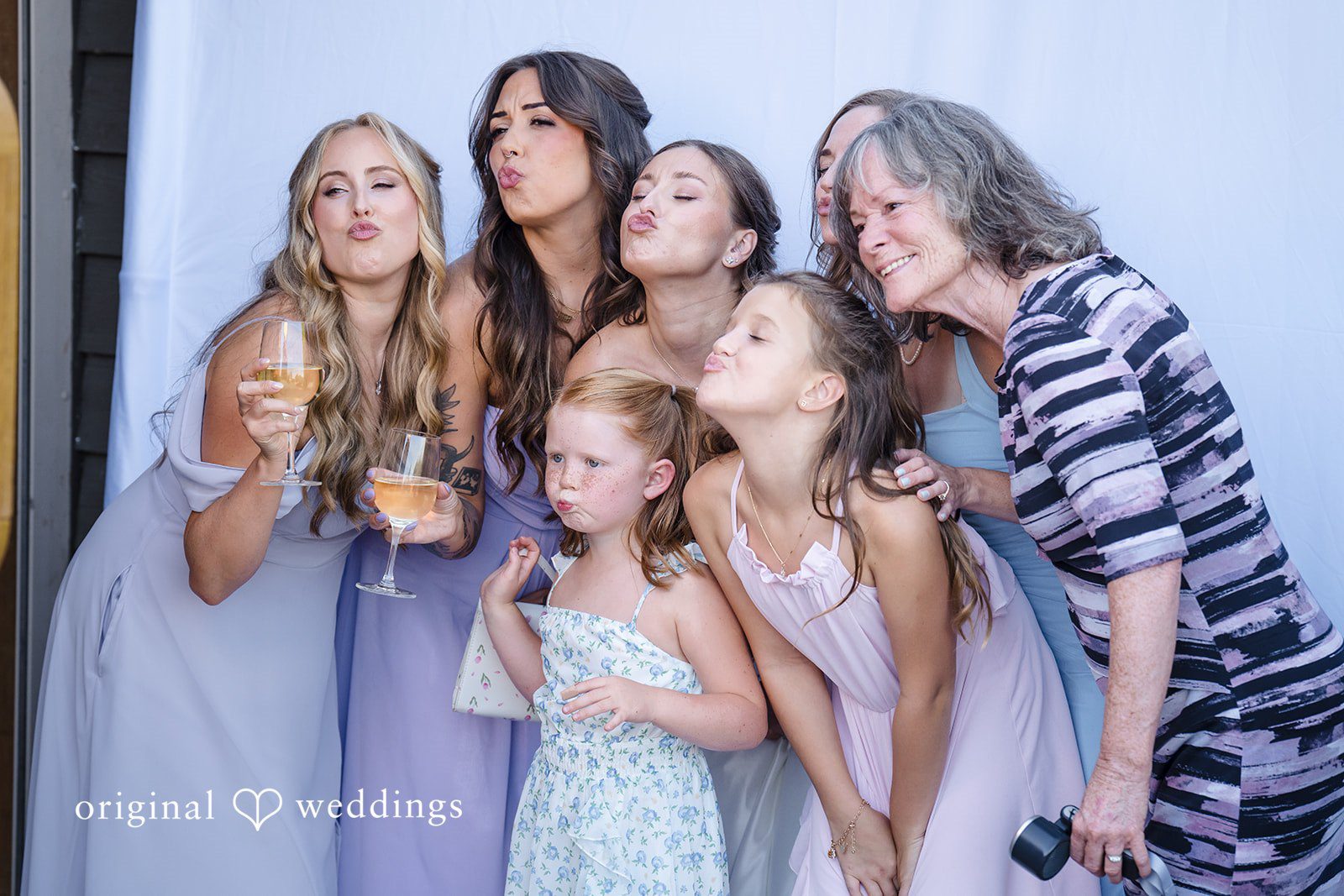 Hanna + Austin Group of women laughing and posing closely together.
