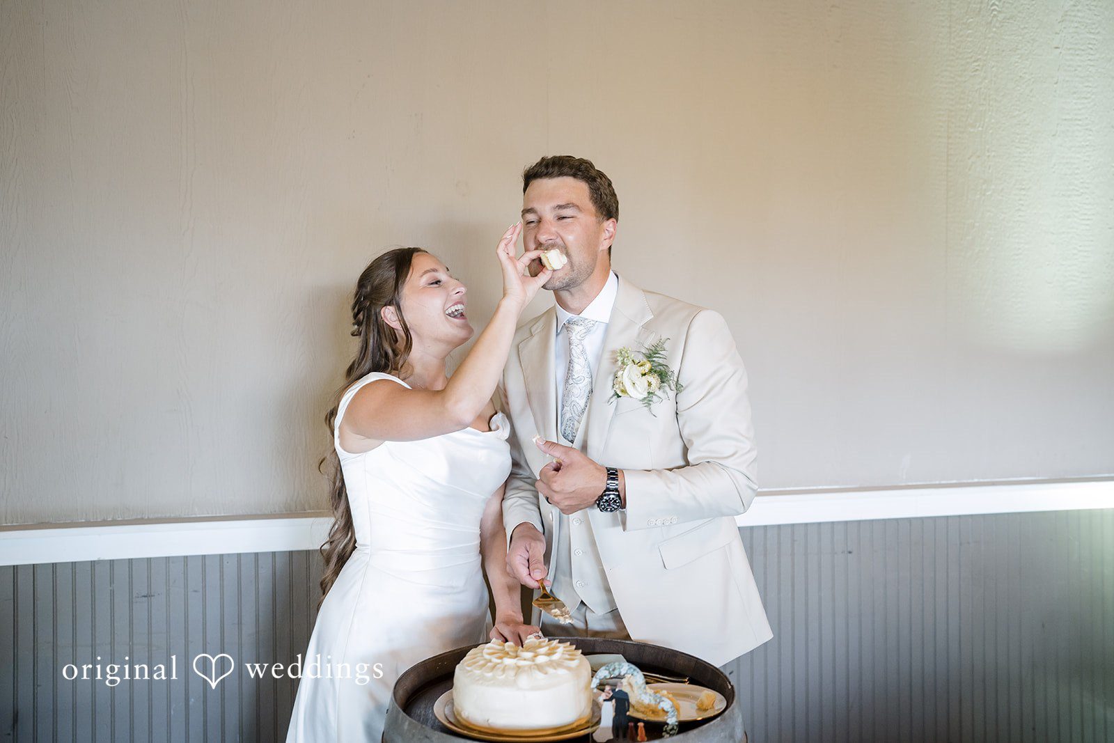 Hanna + Austin A bride feeding a piece of wedding cake to her new husband.