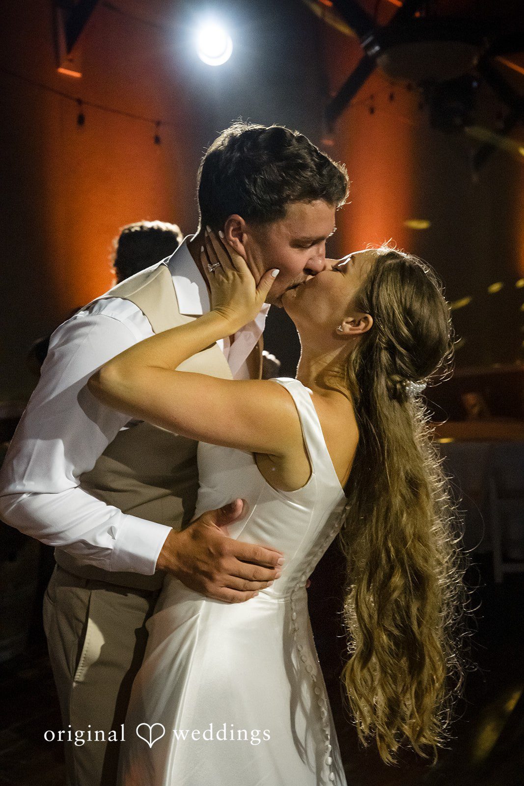 Hanna + Austin A newlywed couple sharing an intimate kiss during their wedding dance.
