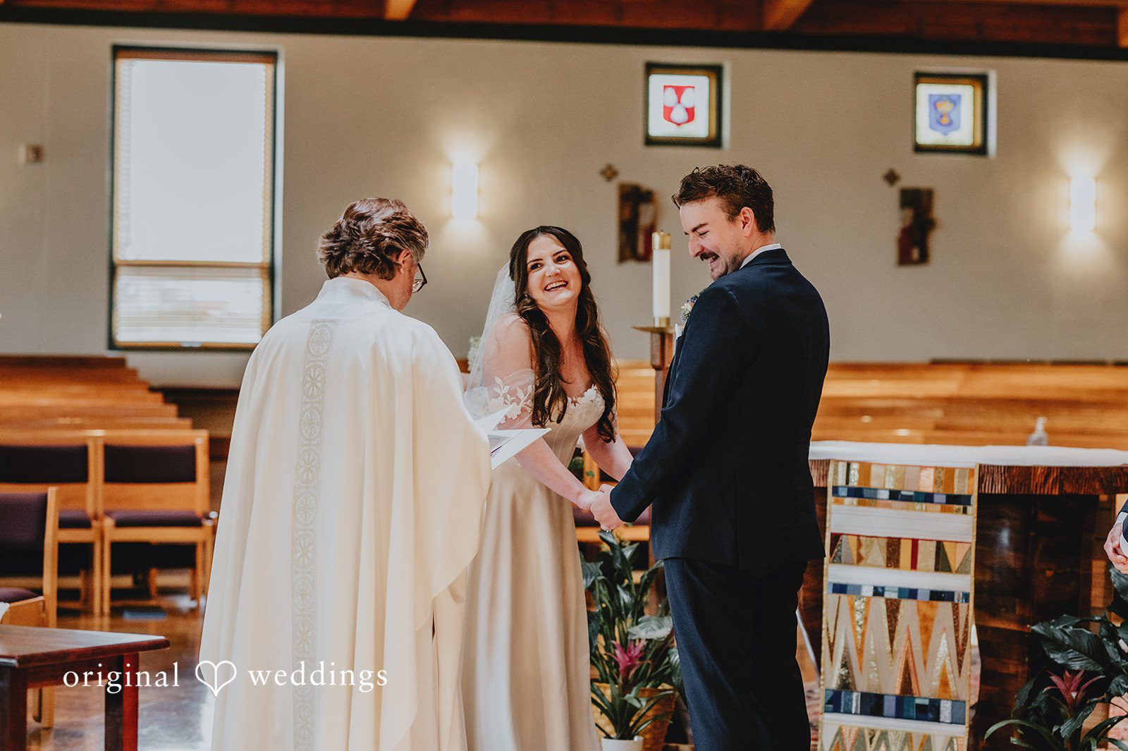Officiant speaking to the bride and groom at the altar.