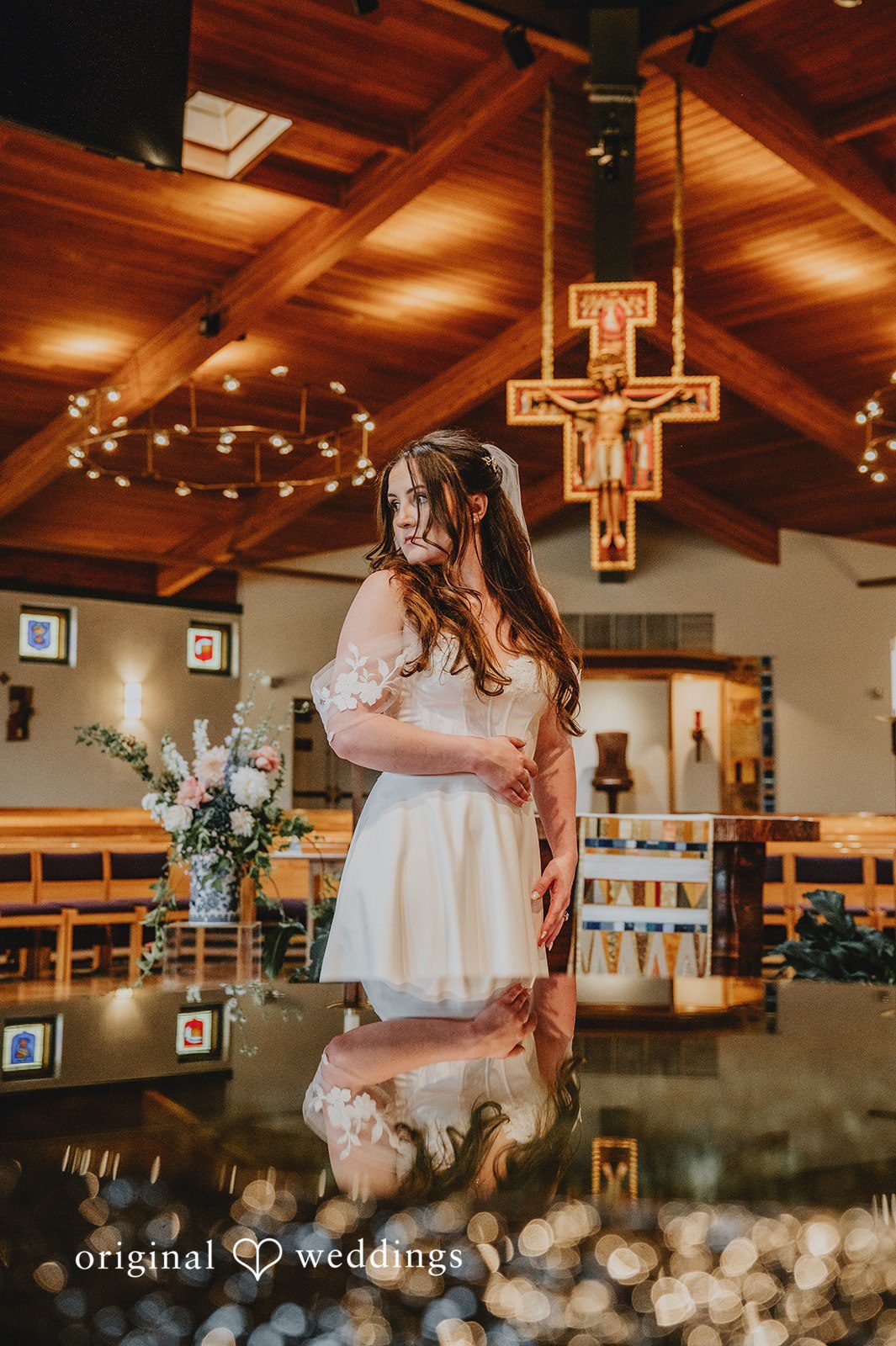 Bride sharing a moment under warm lighting in a reception hall.