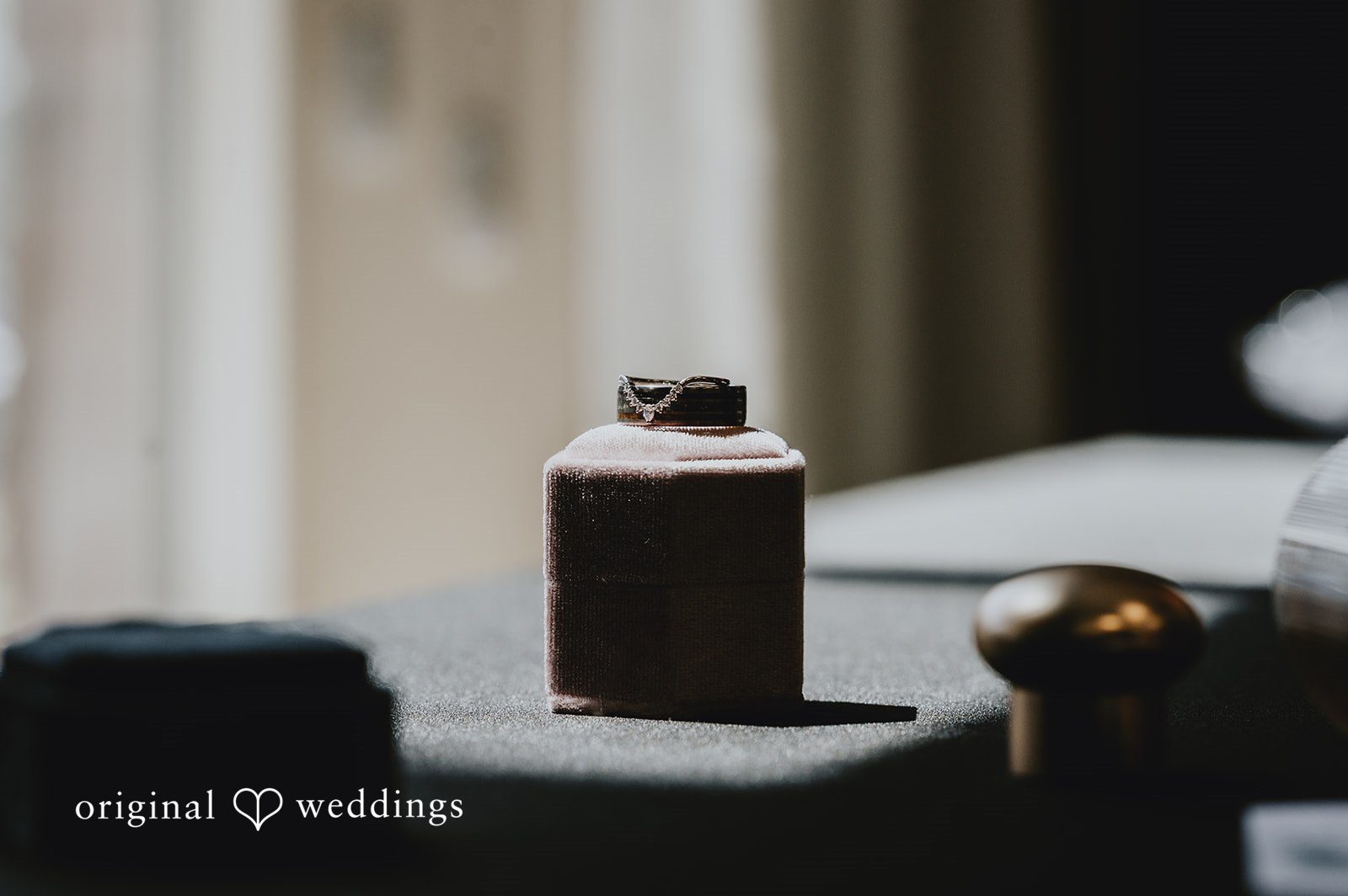 Small dark glass bottle or favor placed on a reception table.