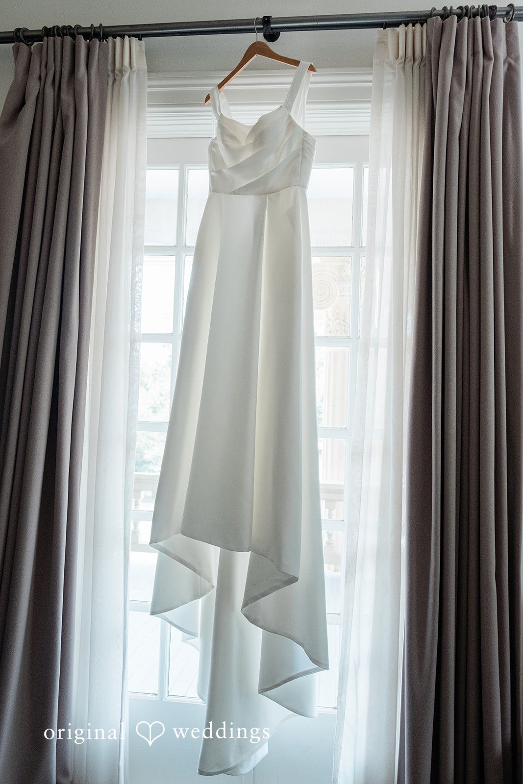 Andrew + Lyndsey The bride's gown gracefully hanging in the lodge
