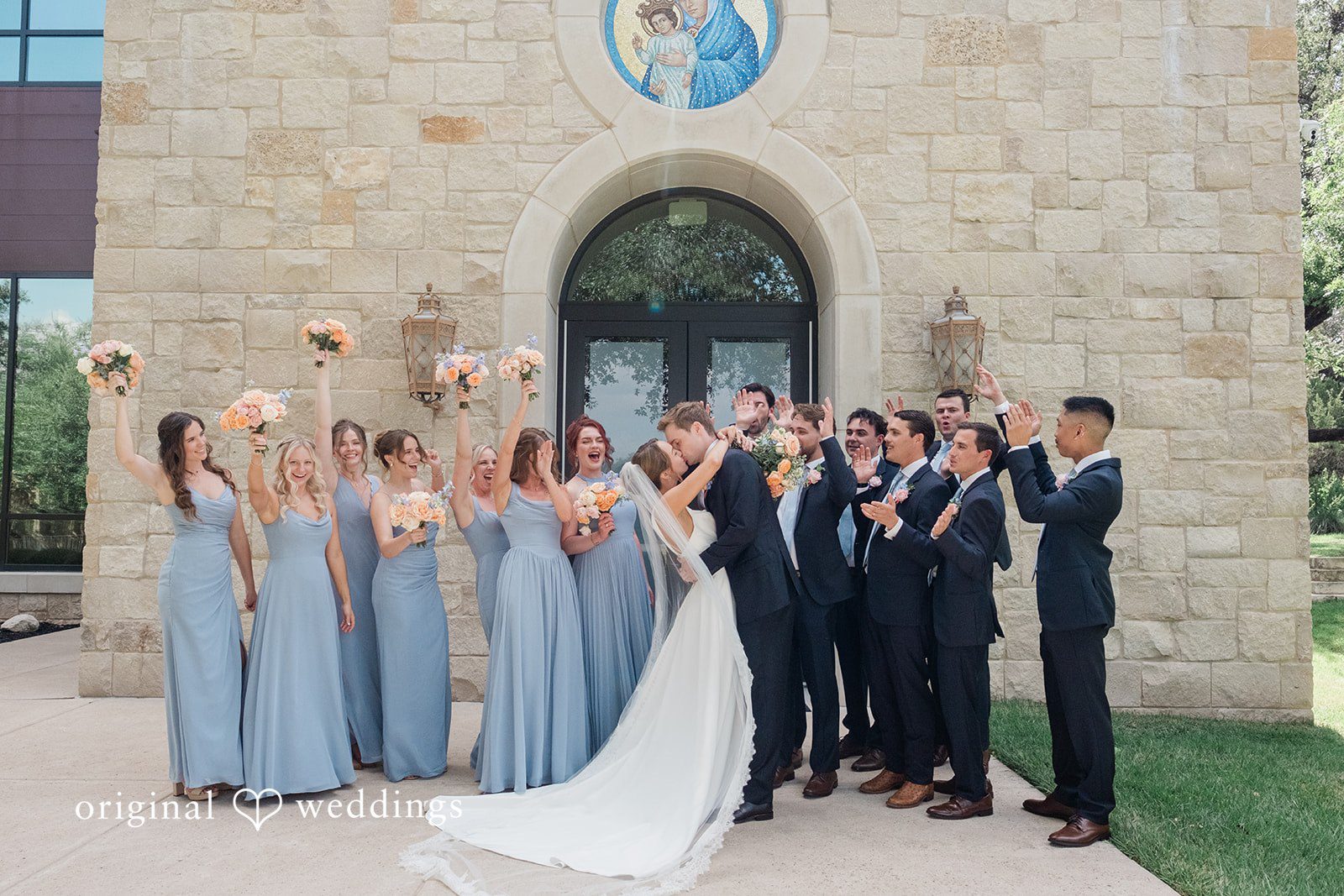 Andrew + Lyndsey Our Austin wedding photographers captured a romantic portrait of the couple while their bridal party cheered them on