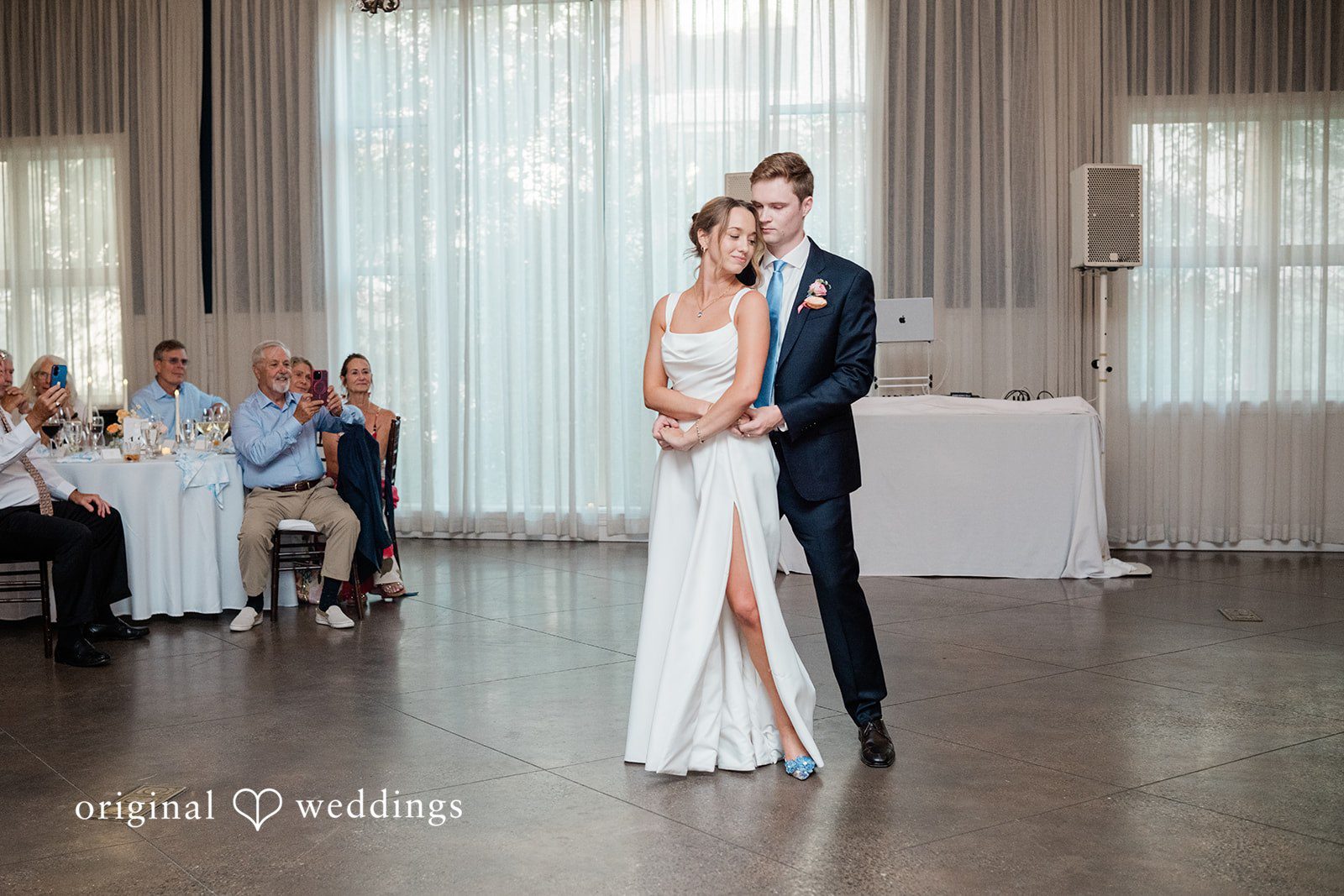 Andrew + Lyndsey The couple dances in the wedding reception hall