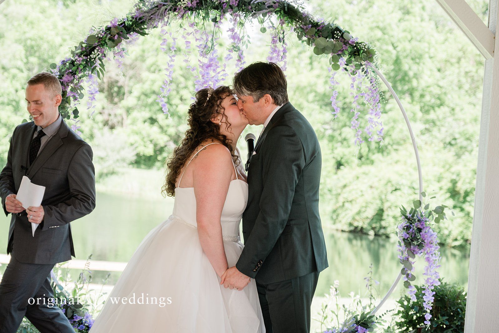 Carly + Seamus Bride and groom sharing a kiss at the altar.