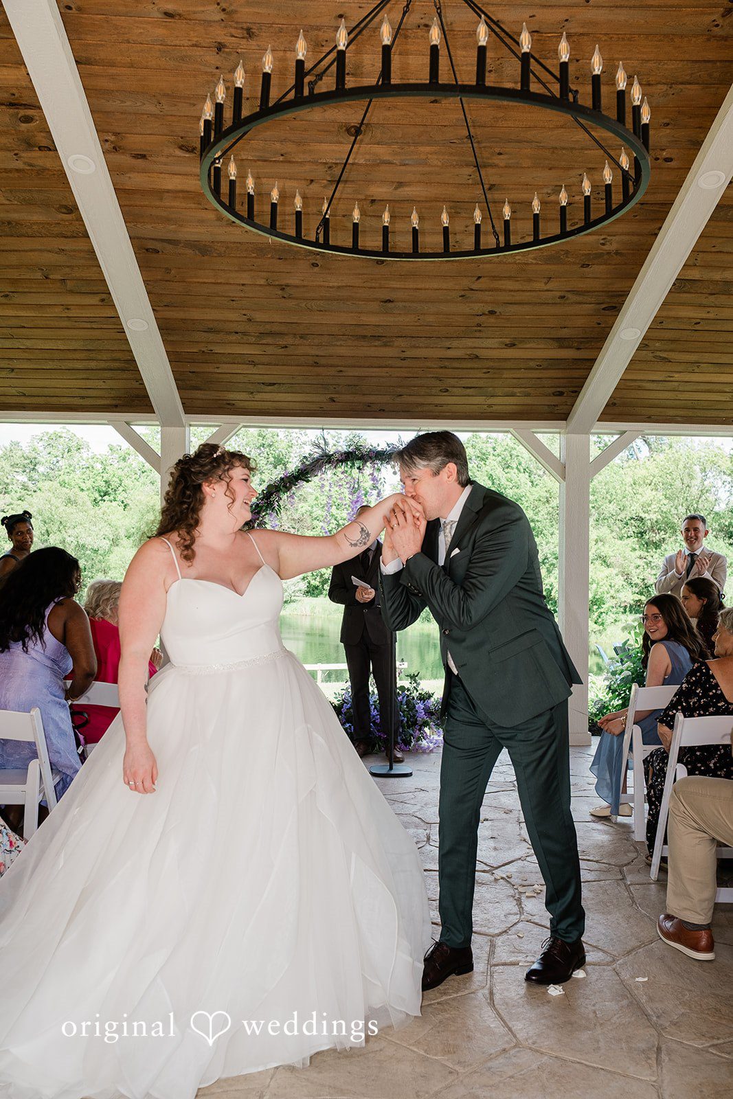 Carly + Seamus Bride and groom walking down the aisle together as guests look on.