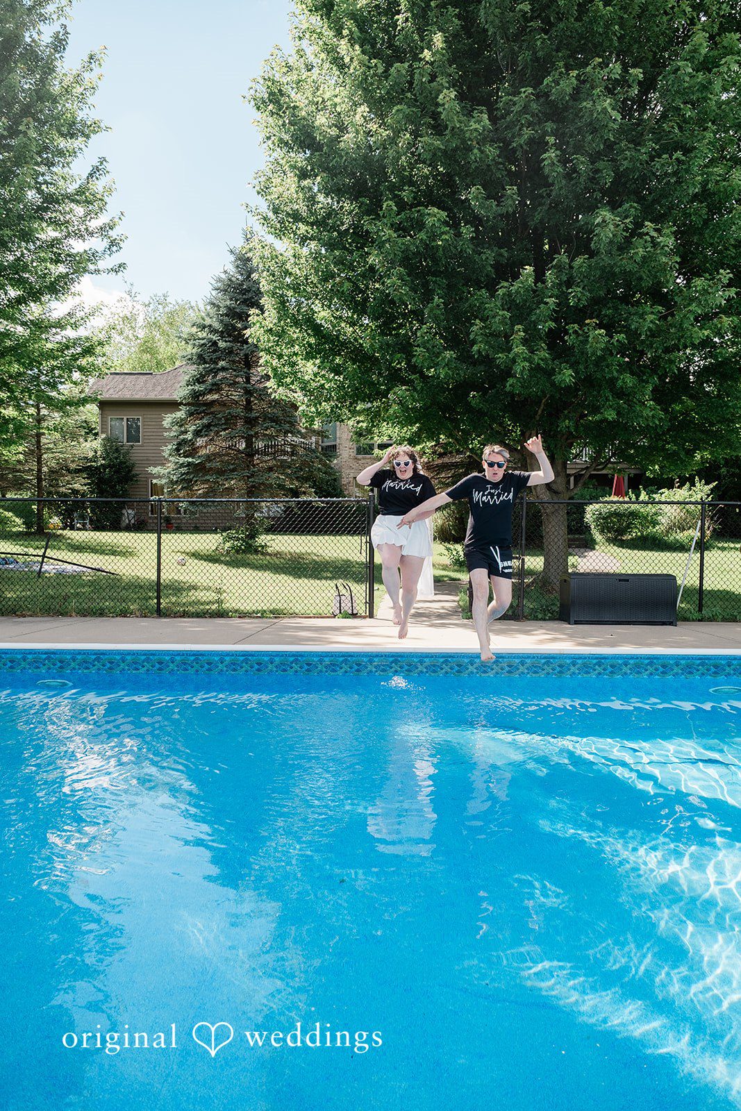 Carly + Seamus Sunny swimming pool with figures blurred in the background.