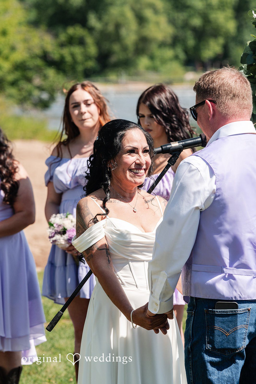 A bride and groom facing each other while reciting vows at the altar.