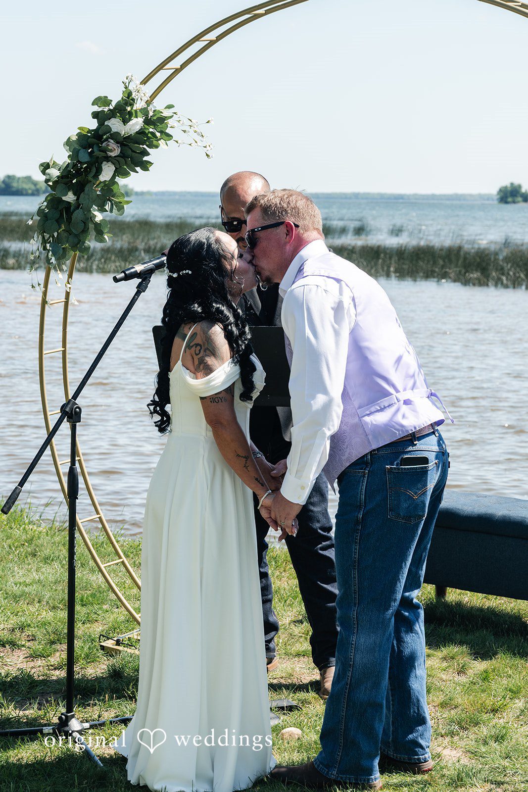 Couple sharing a kiss after wedding ceremony.