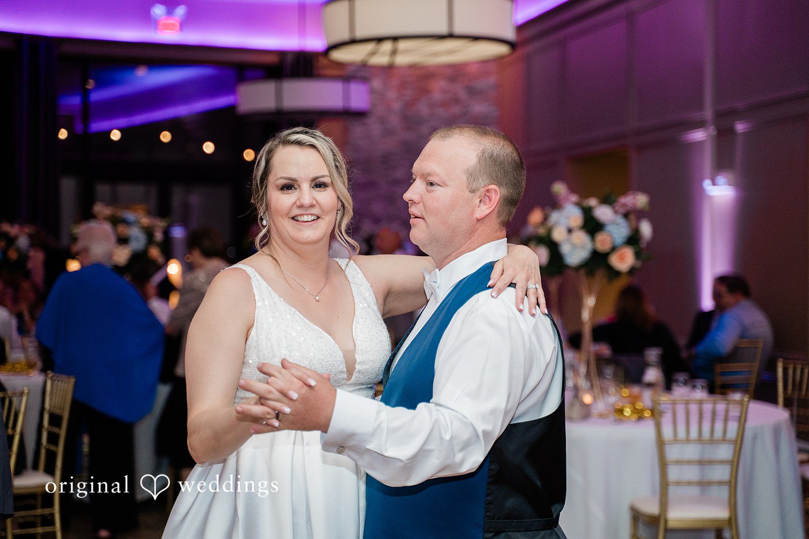 Jessica + Patrick A bride and groom smile warmly at each other while slow dancing.