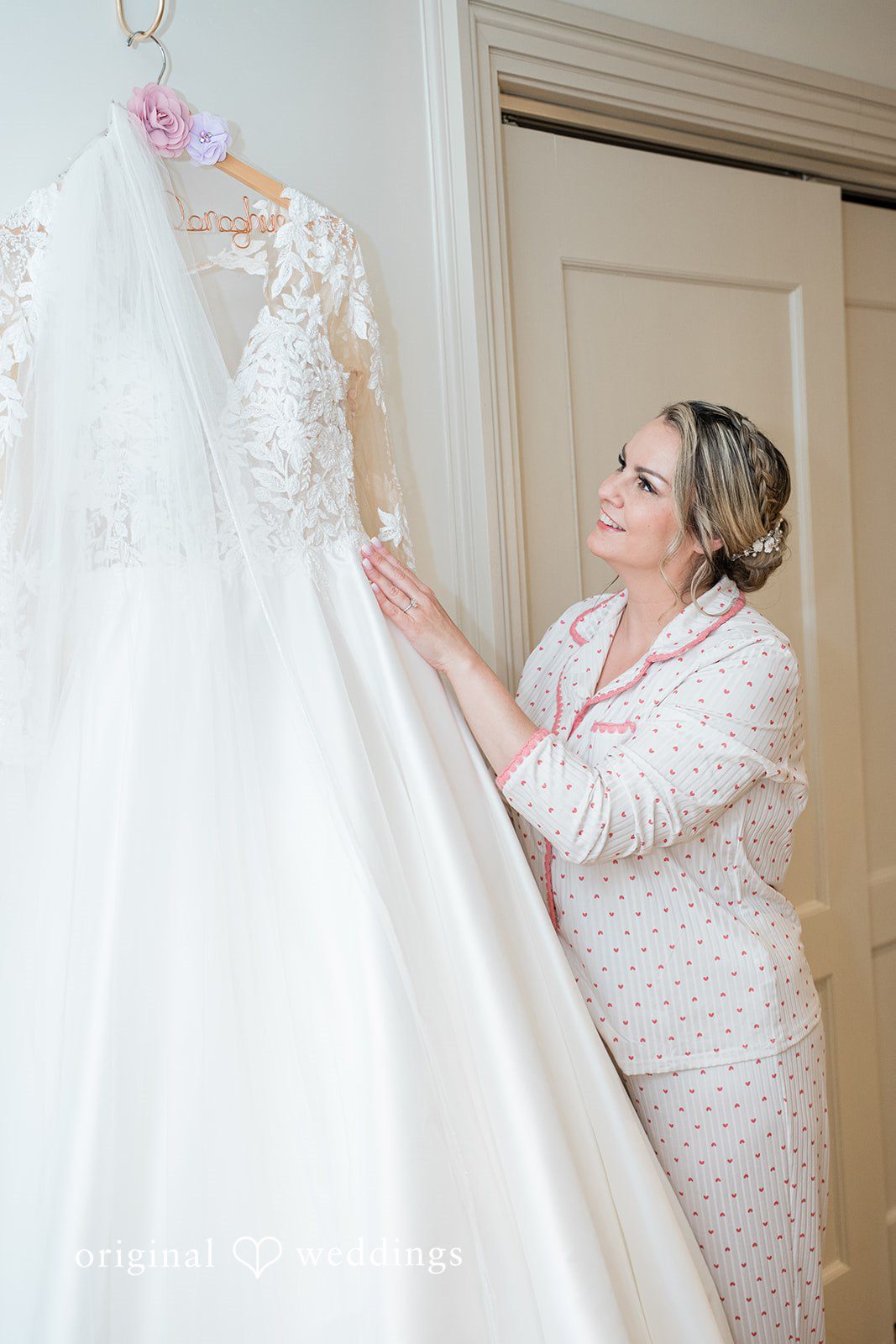 Jessica + Patrick A woman in a lace dress helps adjust the train of a white wedding gown.