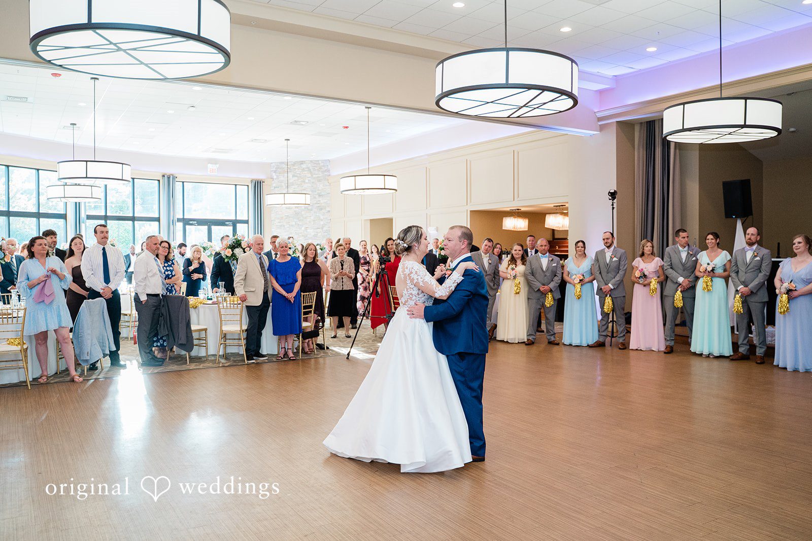 Jessica + Patrick A wide view of a bride and groom dancing on a ballroom floor during their reception.