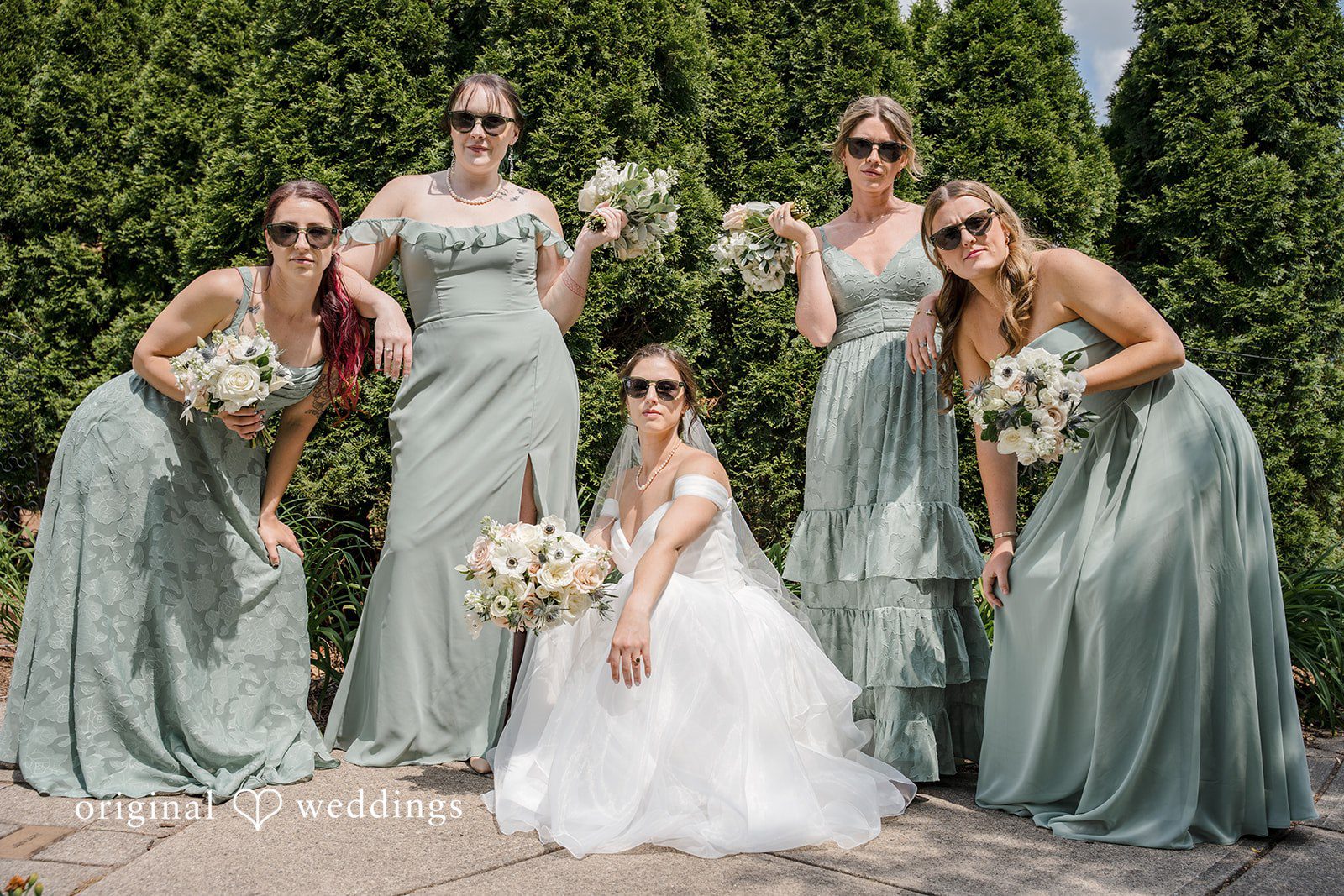 Emily + Maxwell A bride, a flower girl, and four bridesmaids posing together.