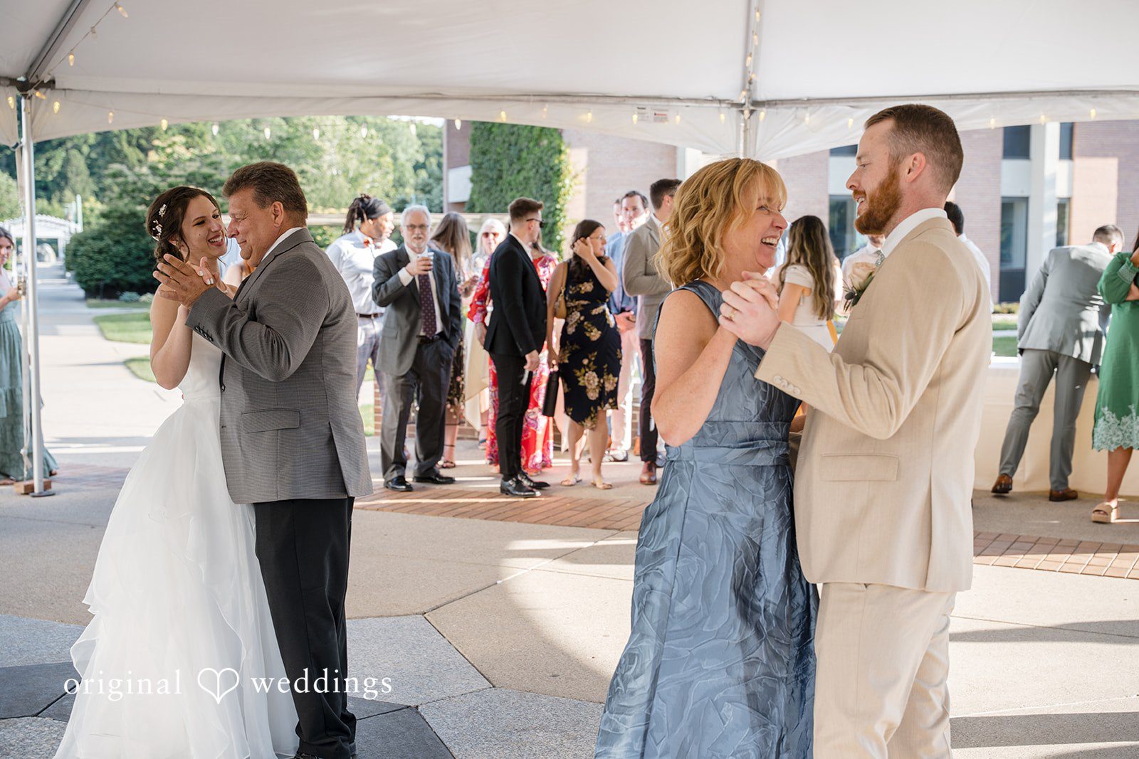 Emily + Maxwell Guests mingling and dancing together at a lively wedding reception.
