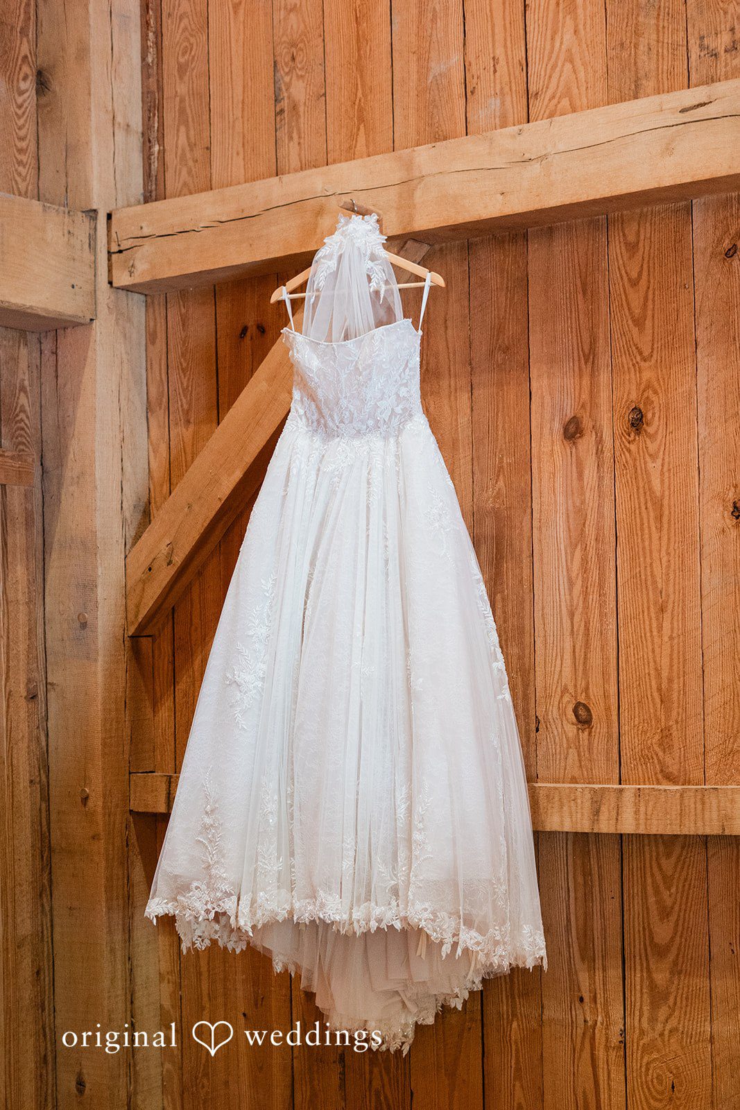 Beautiful picture of wedding gown hang against the wall