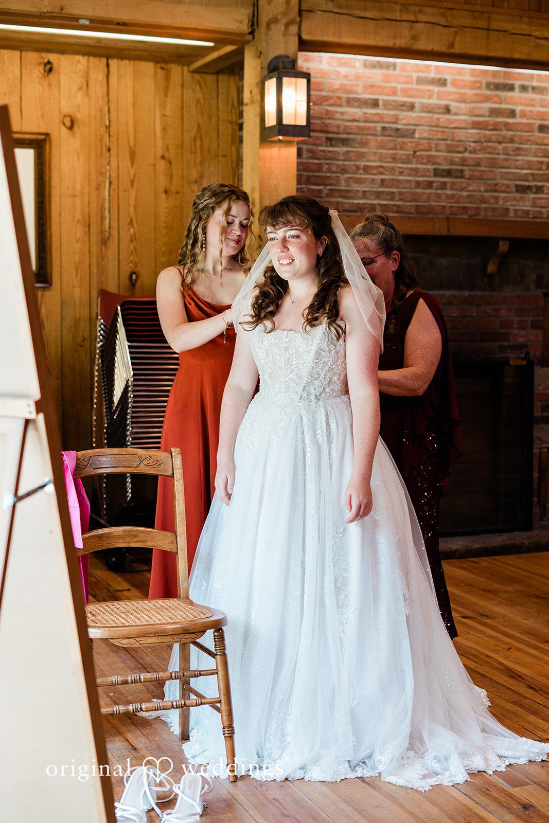 Lovely bride getting ready with the help of bridesmaids