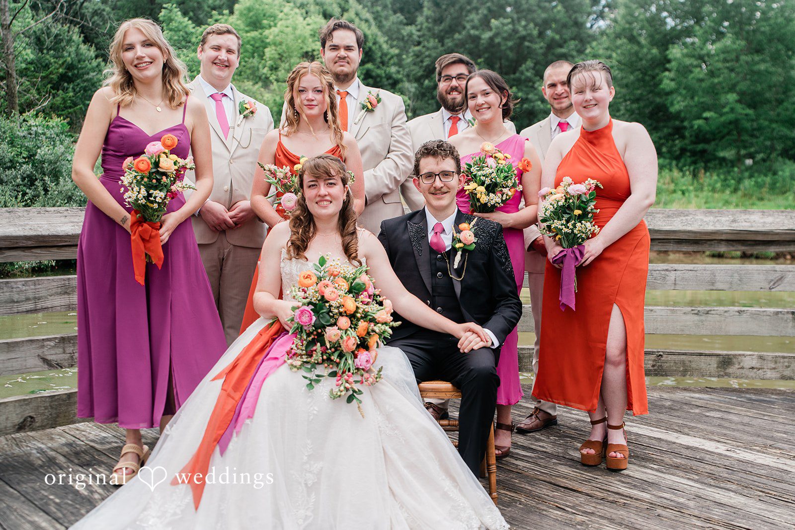Lovely picture of couple with the bridesmaids and groomsmen in a backyard
