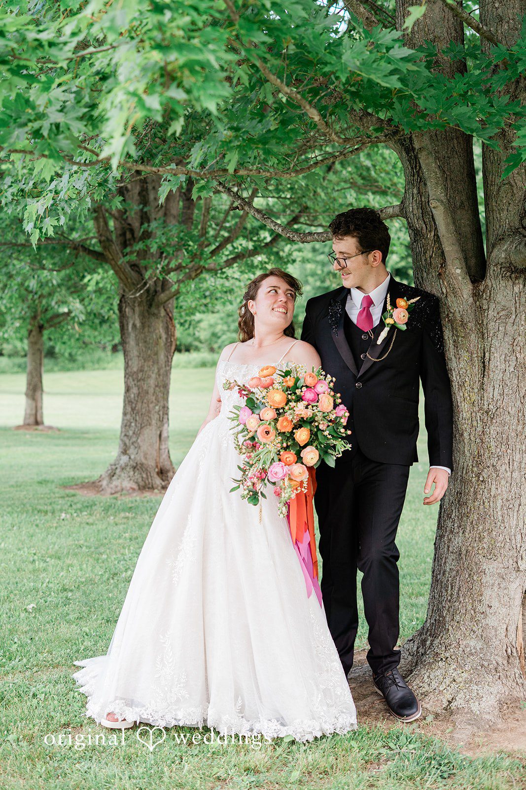 Bride and groom looking at each other standing in a garden