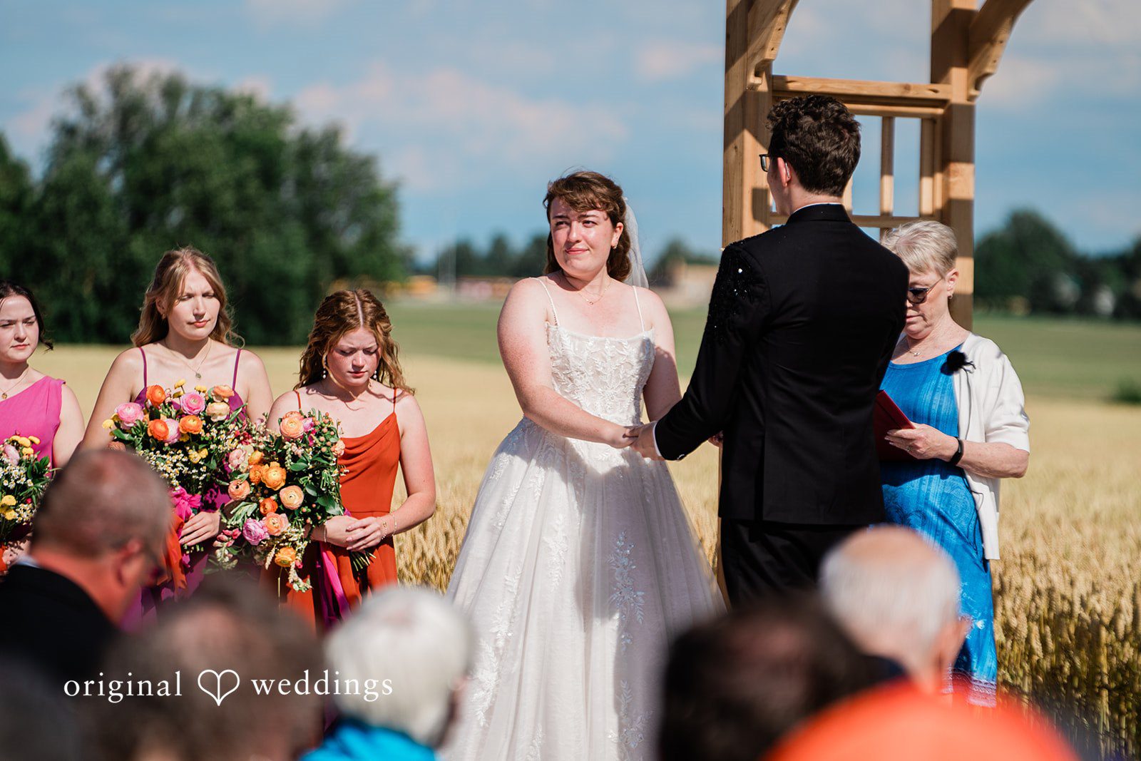 Bride looking at the guests during wedding photoshoot in the backyard