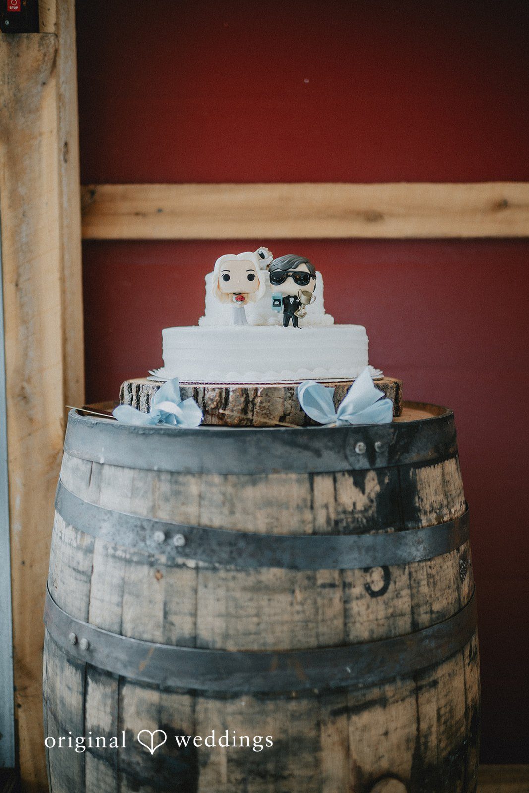 Abby + Tyler Cake placed on the barrel with a cute topper