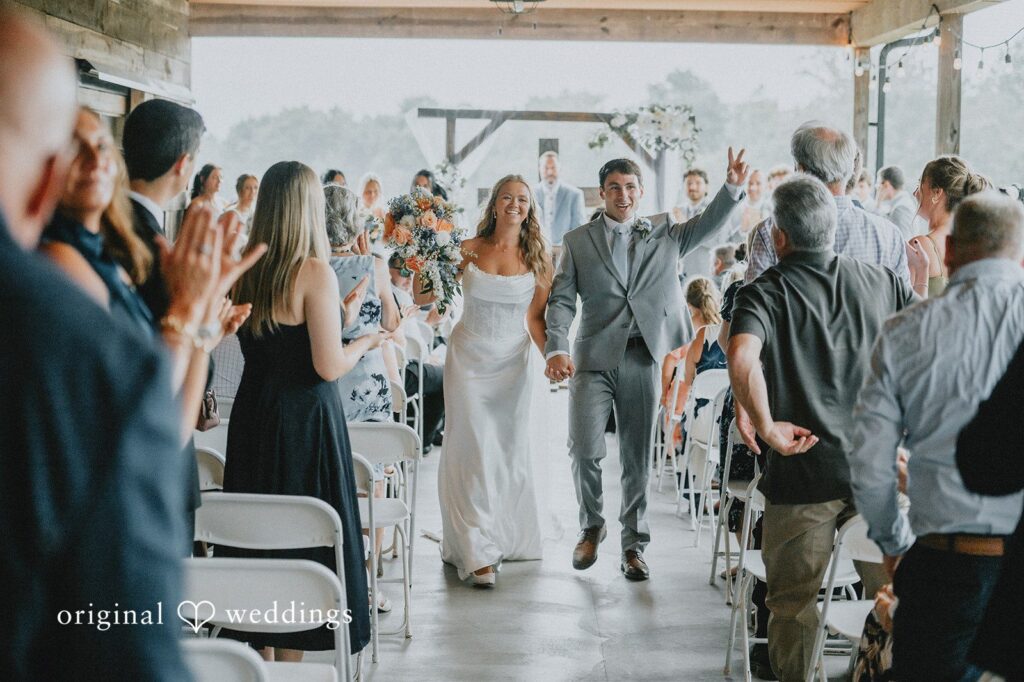 Abby + Tyler Our Cincinnati wedding photographers captured a joyful portrait of the couple making a grand exit after an Ohio Backyard ceremony
