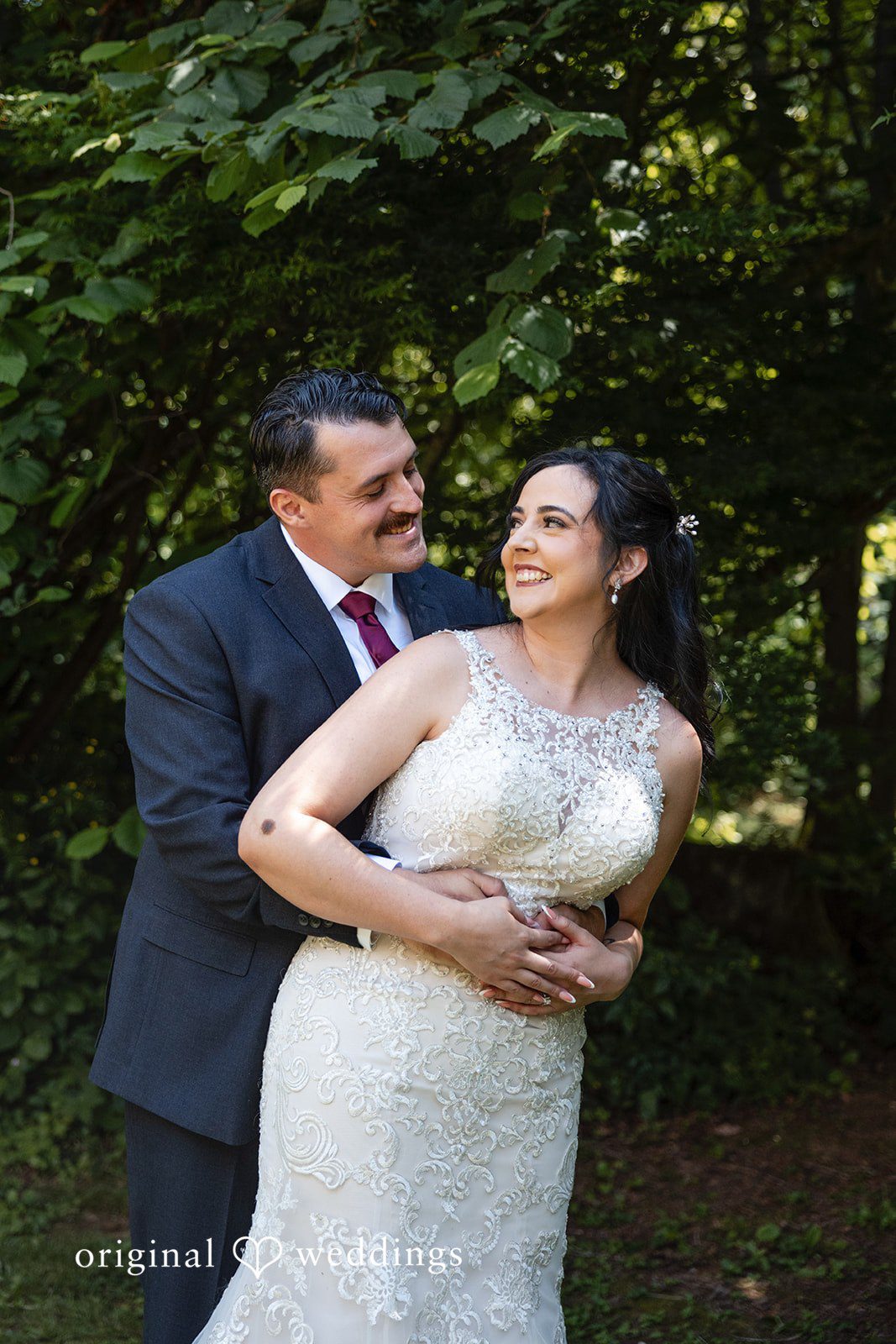 Emotional wedding day hug between couple