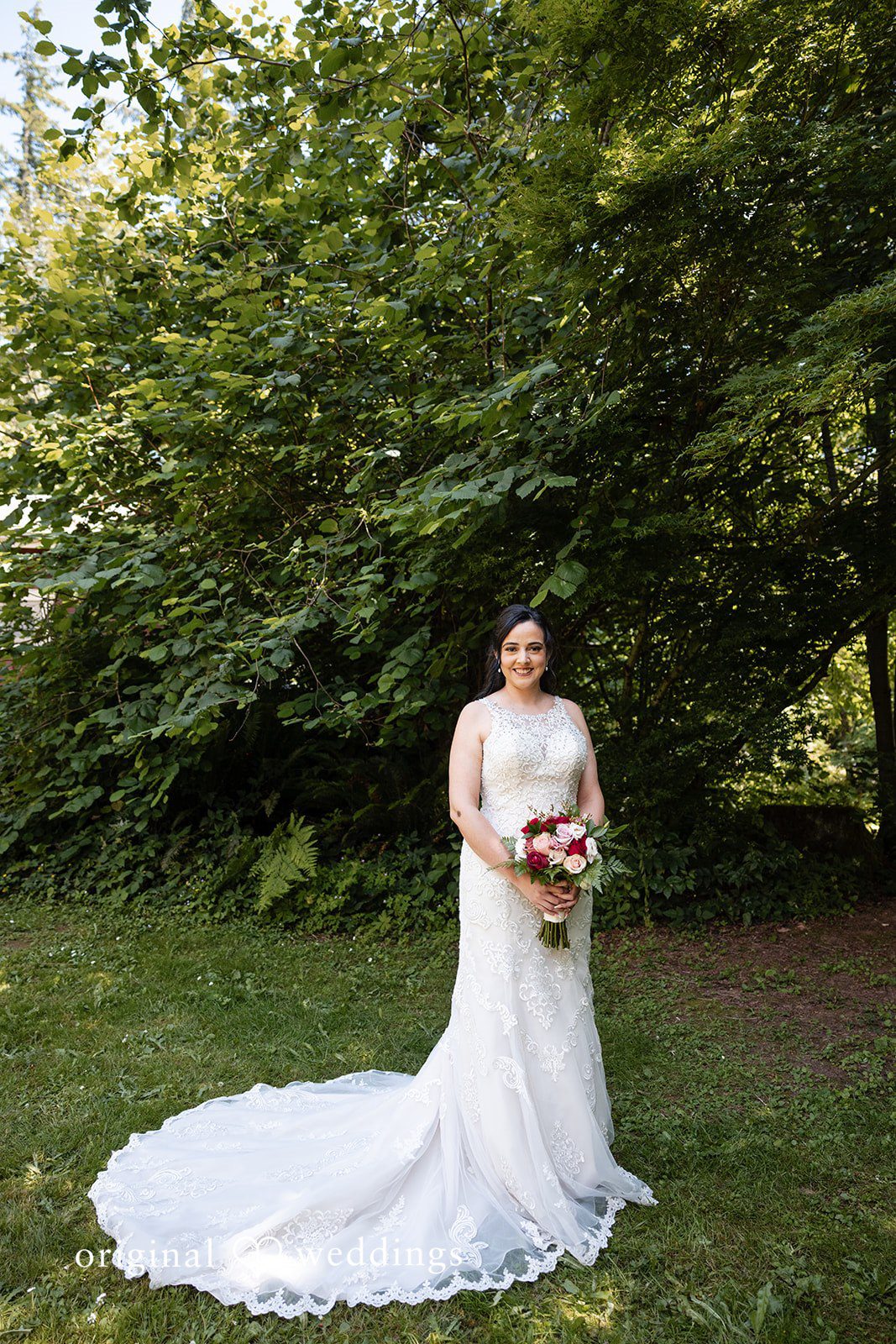 Happy bride holding floral bouquet