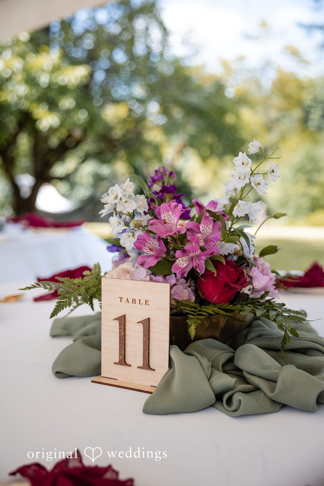 Wedding table with floral decoration and number 11 board