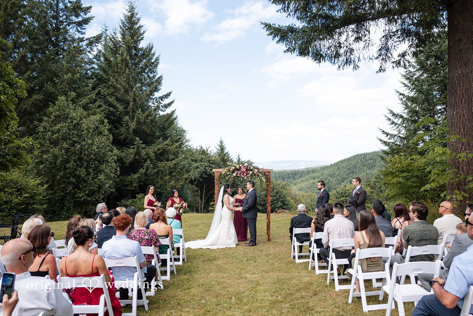 Bride and groom exchanging loving looks to each other infront of priest