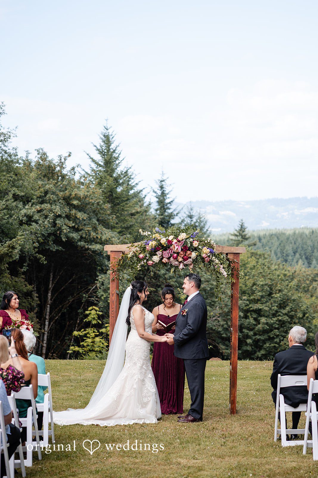 Couple sharing a romantic ceremony moment infront of priest