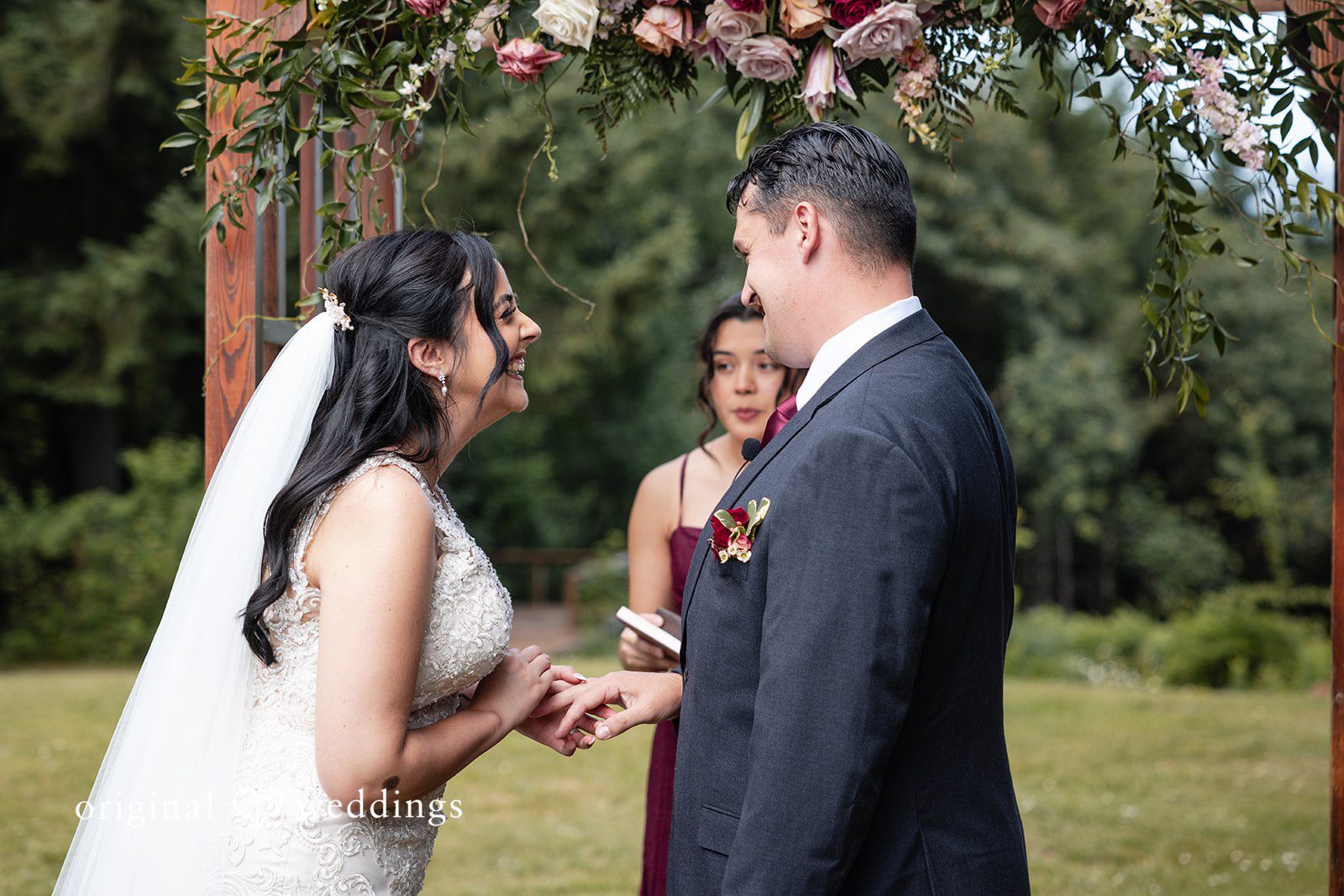 Bride and groom putting rings on each other