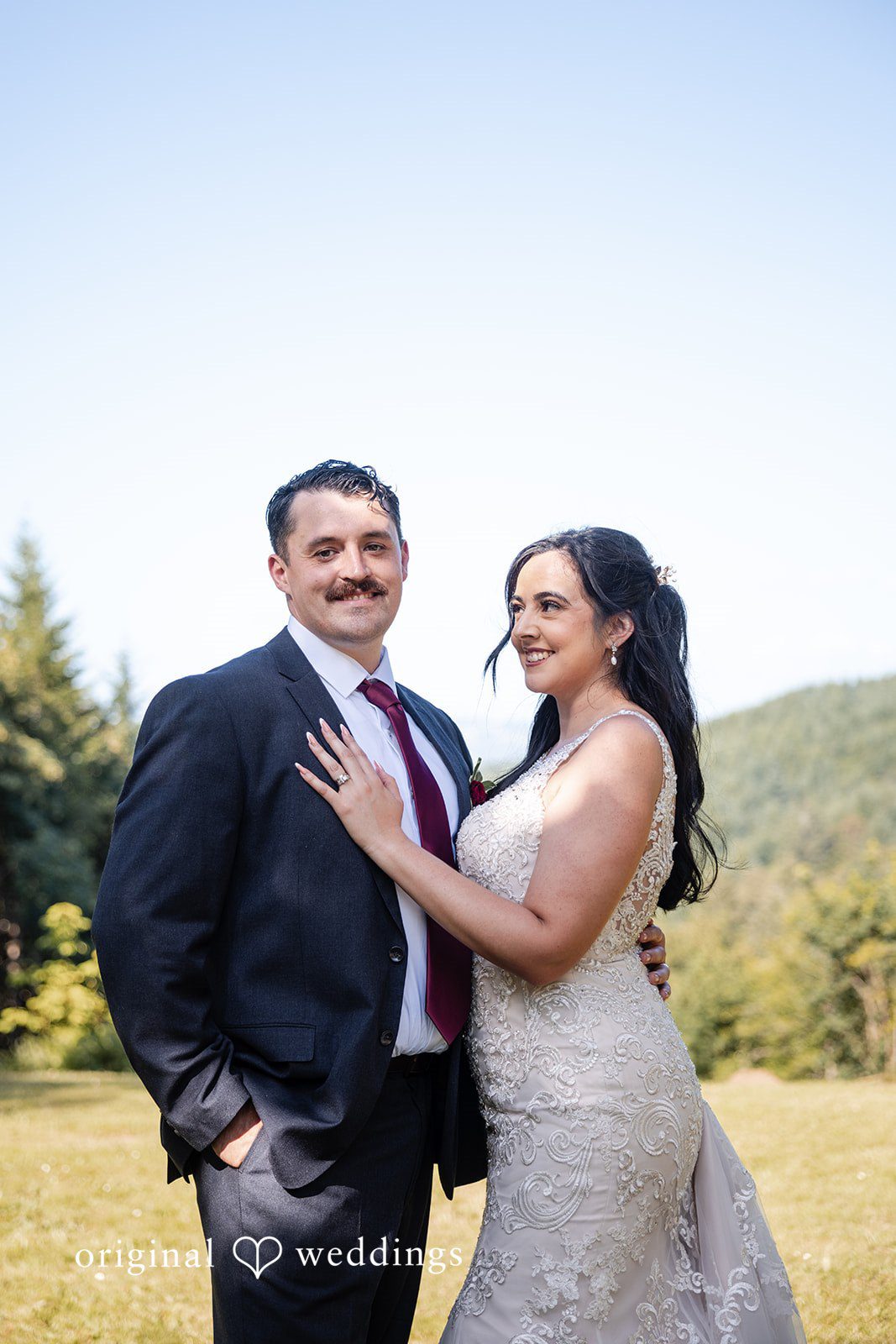 Bride and groom sharing a loving pose while smiling