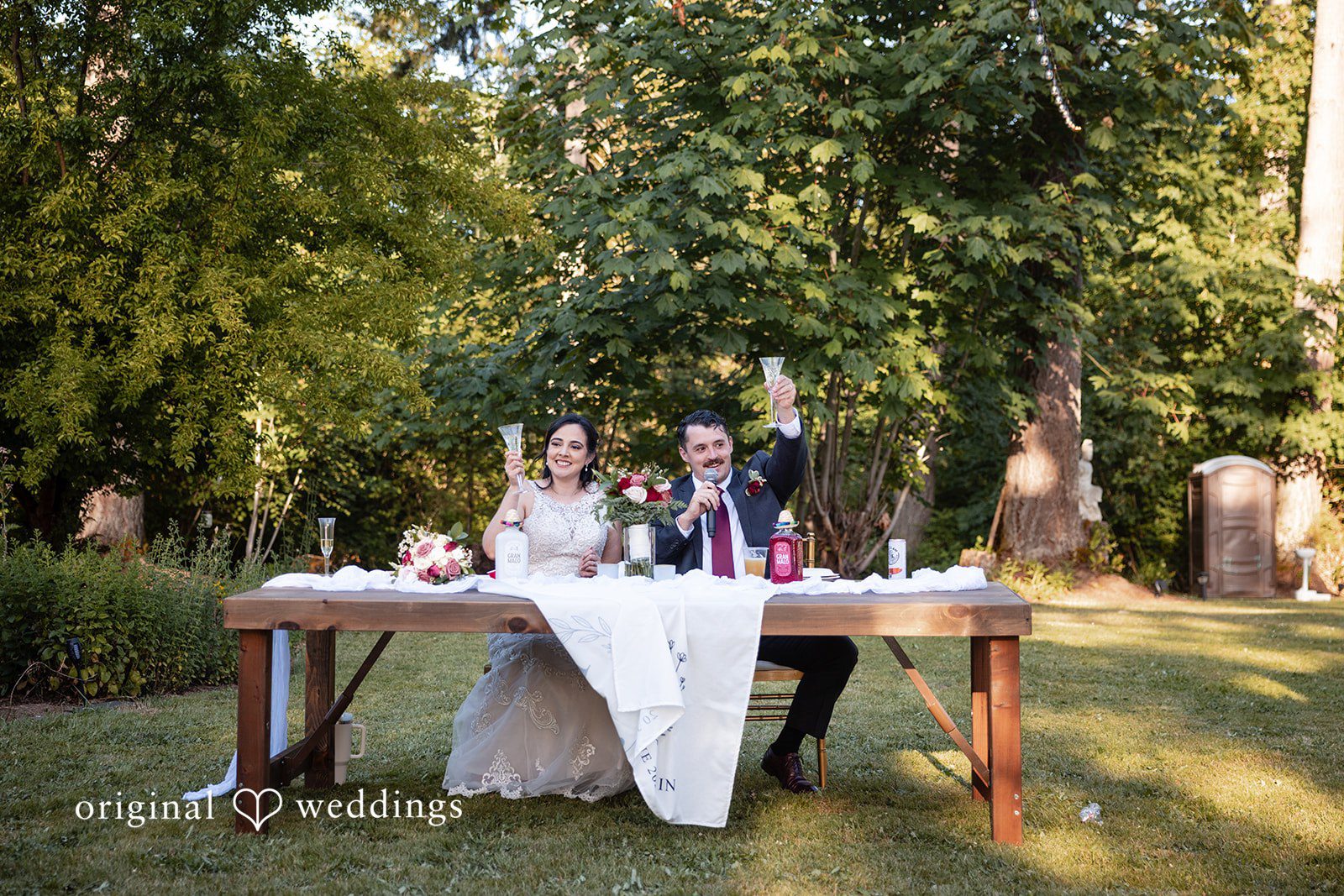 Bride and groom celebrating at reception table