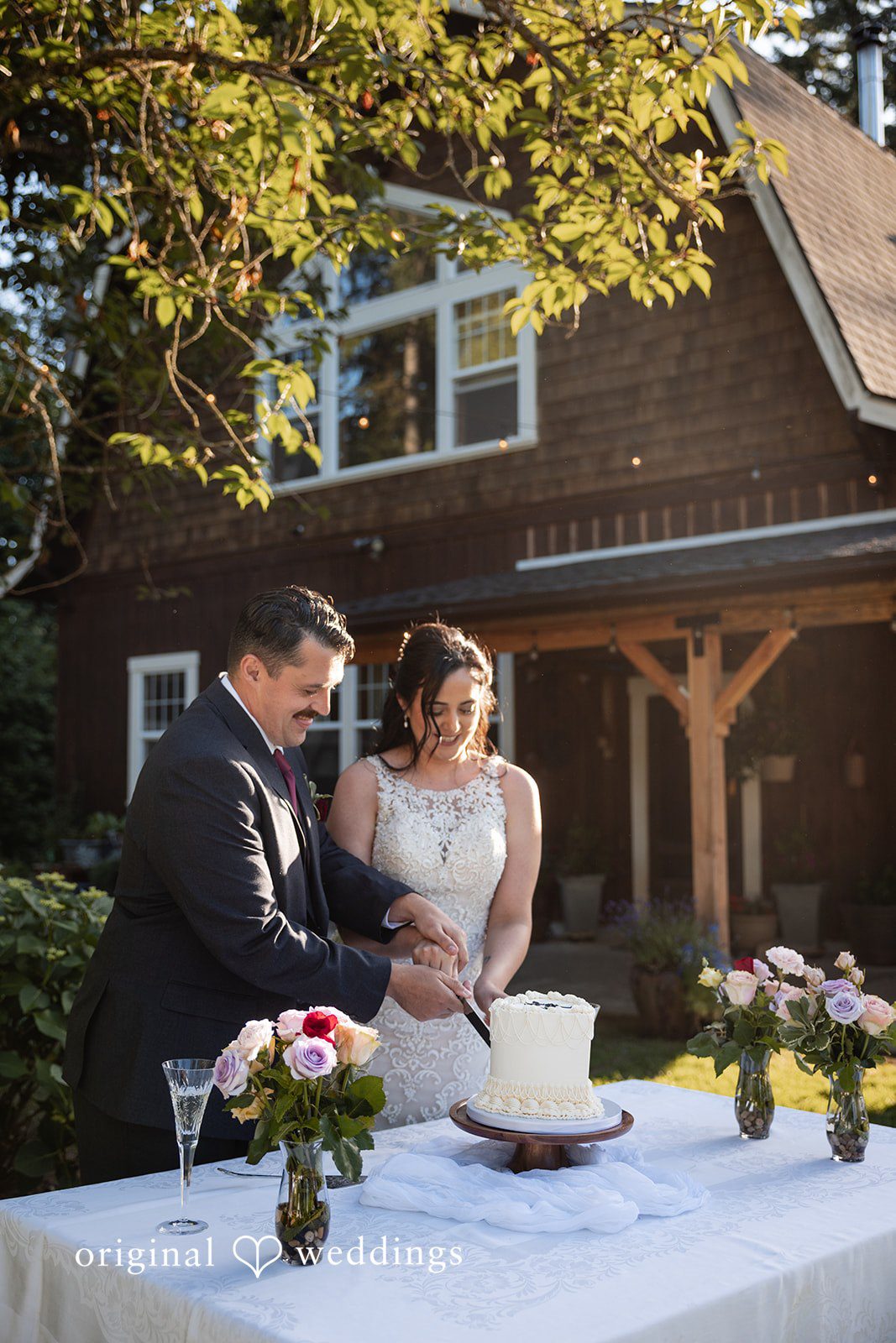 Portland Wedding Photographers capturing couple cutting wedding cake by Original Weddings