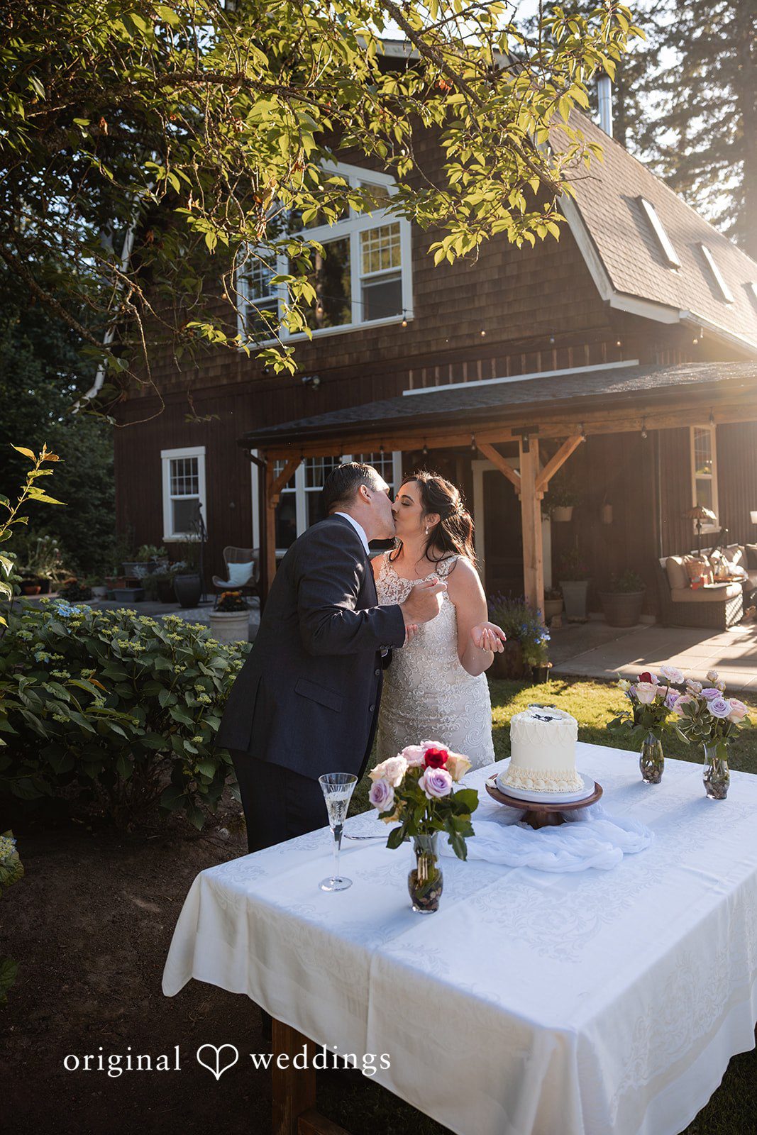 Portland Wedding Photographers capturing couple feeding cake and kissing by Original Weddings