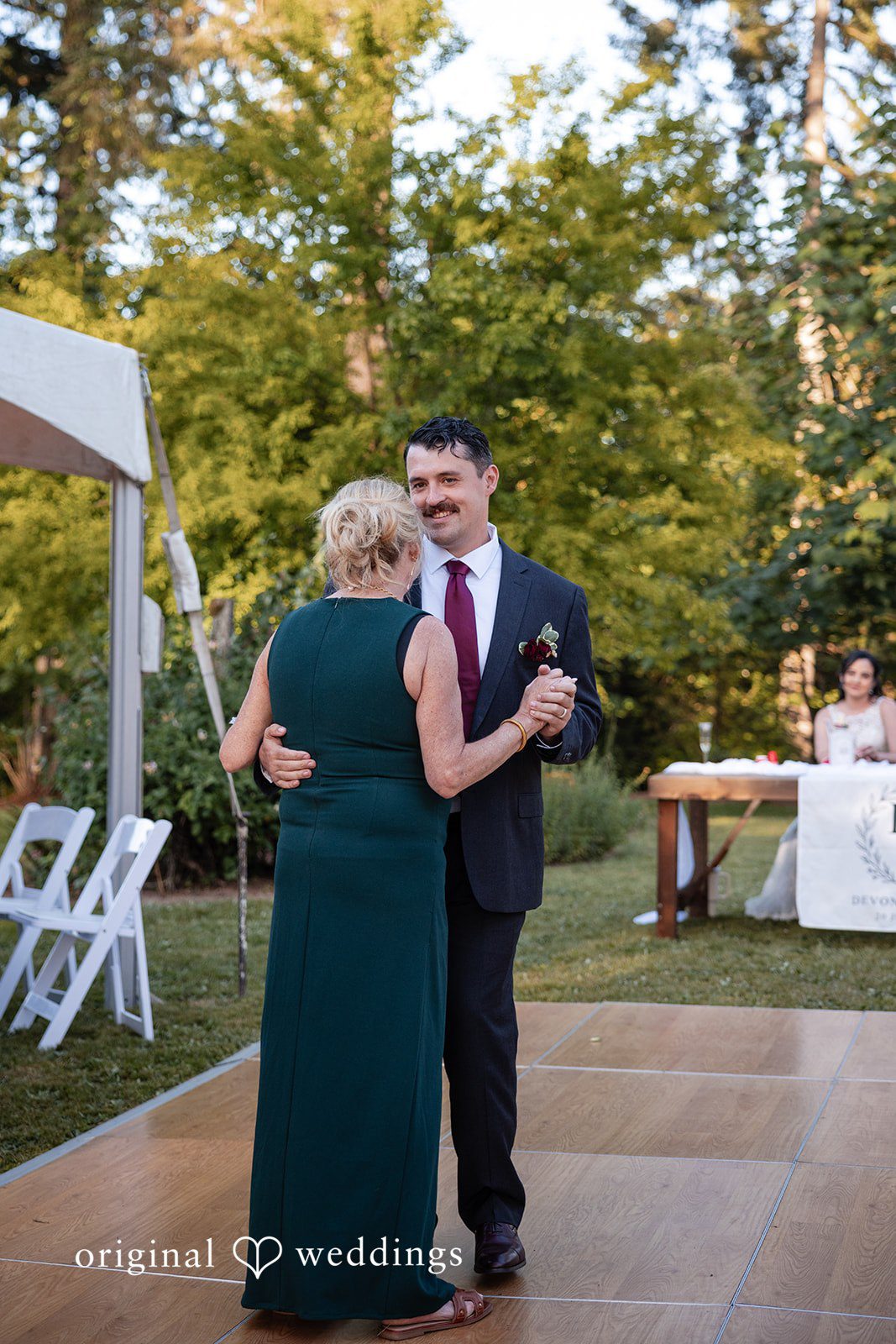 Groom enjoying wedding dance with someone