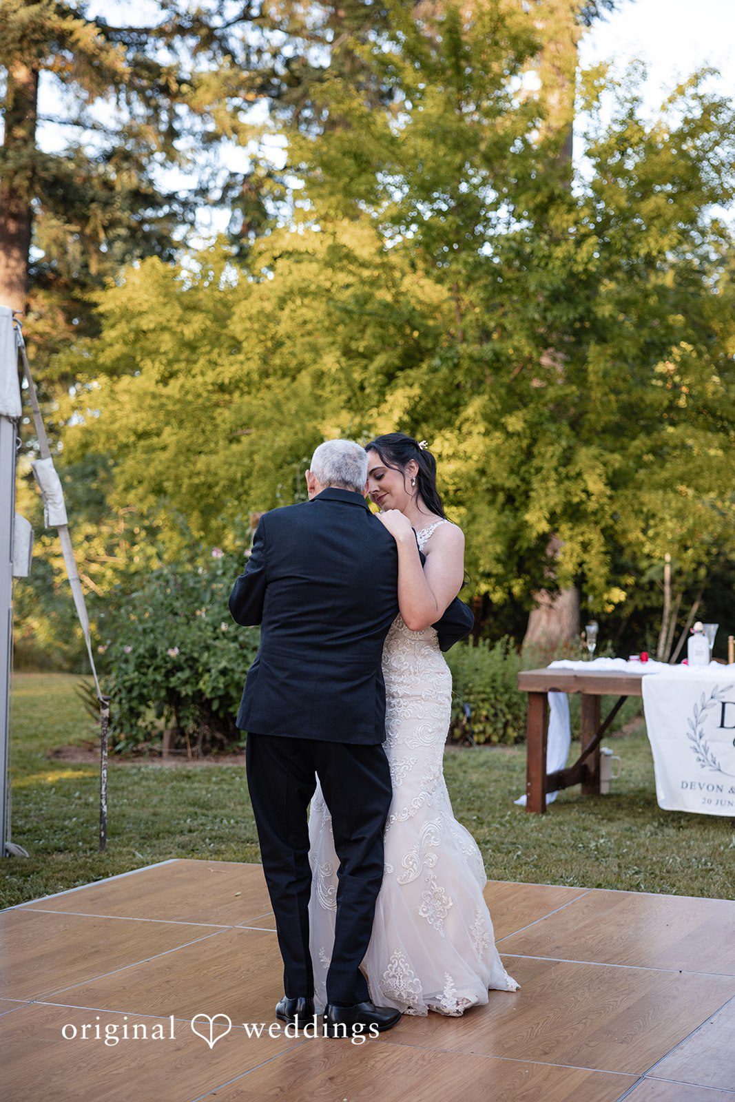 Bride enjoying reception dance with someone