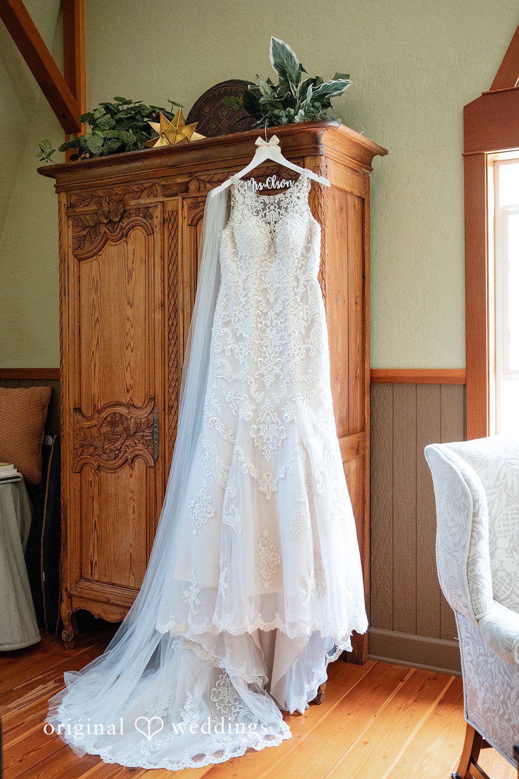 Elegant bridal dress hanging on cupboard