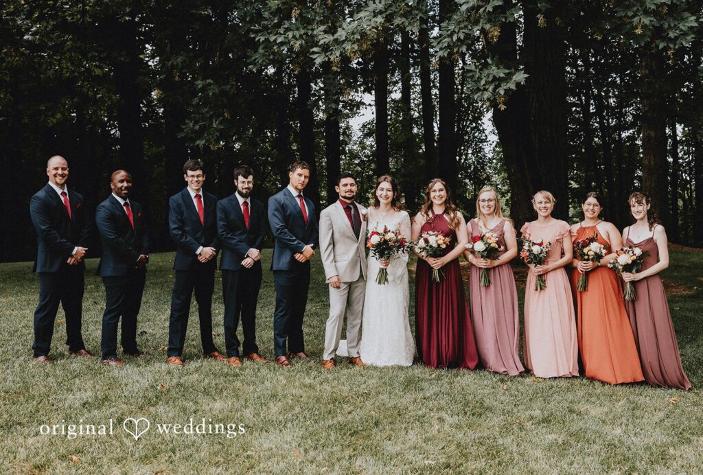 Catherine + Gabriel Wedding party consisting of bridesmaids and groomsmen posing in a line among trees captured by Portland Wedding Photographers from Original Weddings.