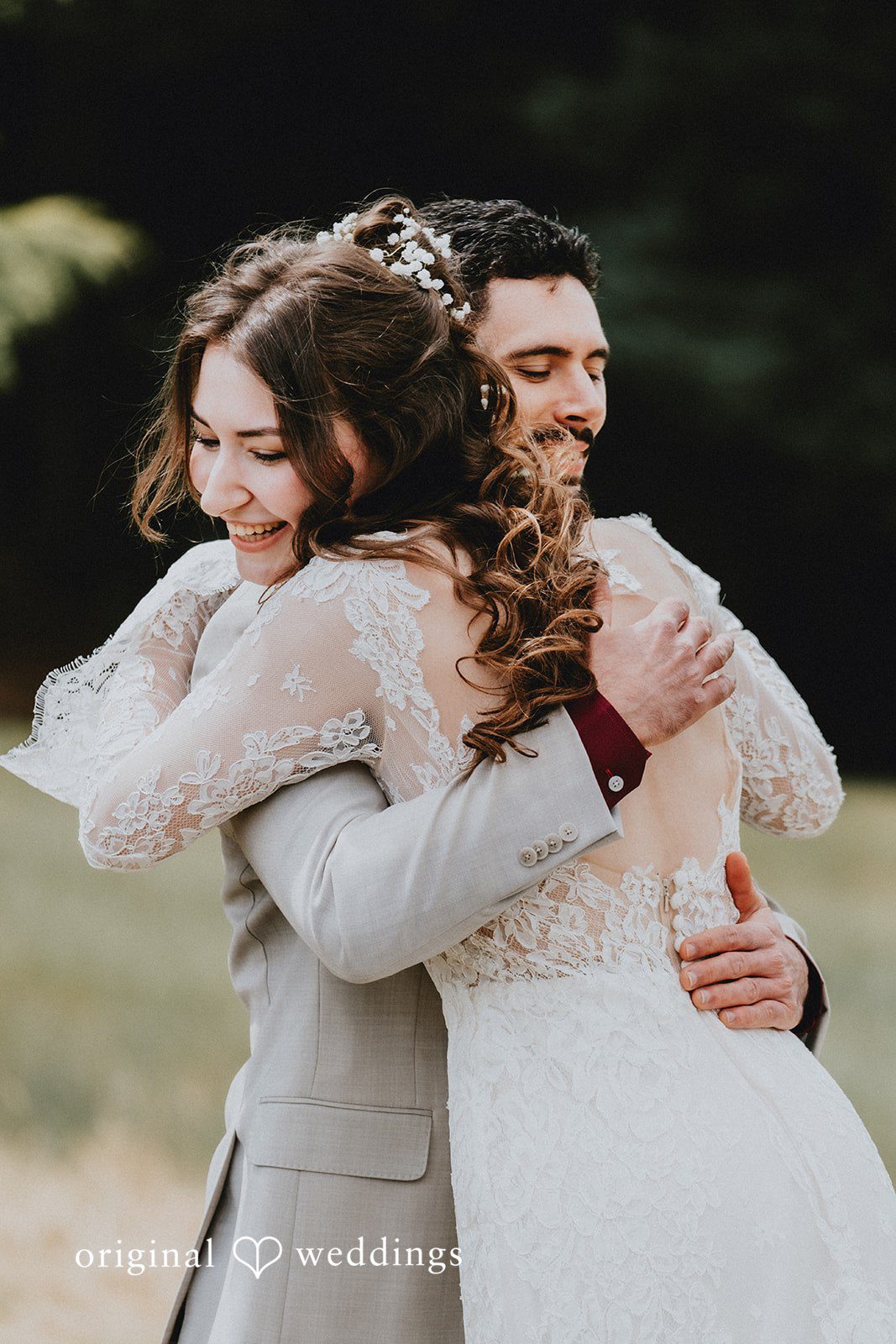 Catherine + Gabriel Bride and groom hugging each other closely during a candid moment.
